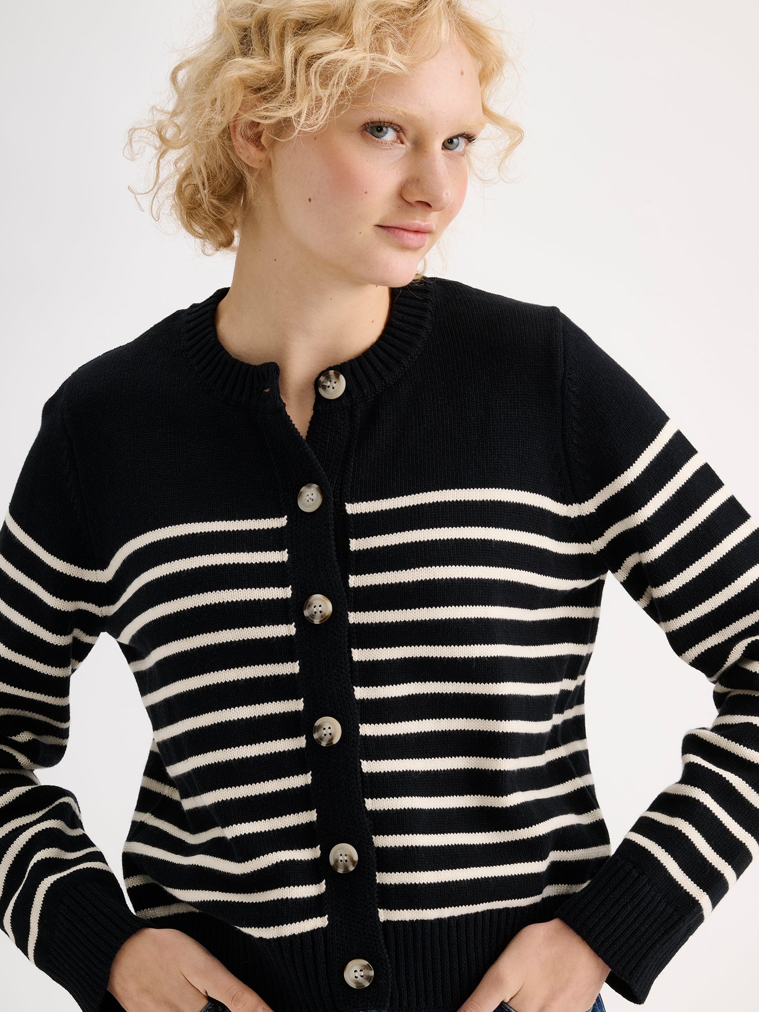Nanso women's straight-cut striped Mira knit cardigan with buttons on a model, close-up.