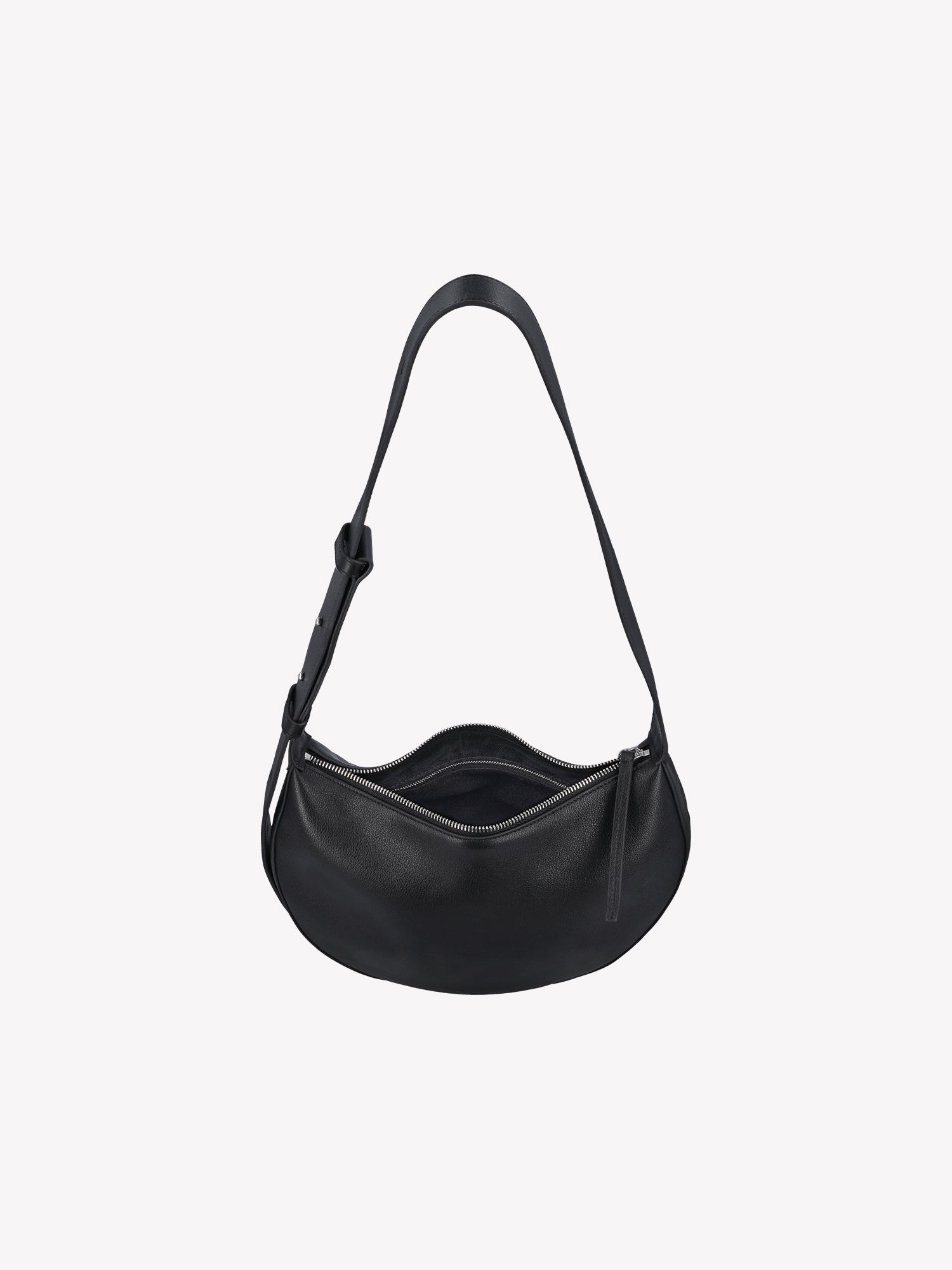 Nanso OLKA KUU - half moon-shaped leather shoulder bag in black. Crafted with a sleek silhouette and practical zip closure and a comfortable shoulder strap. Product picture of the bag from above.