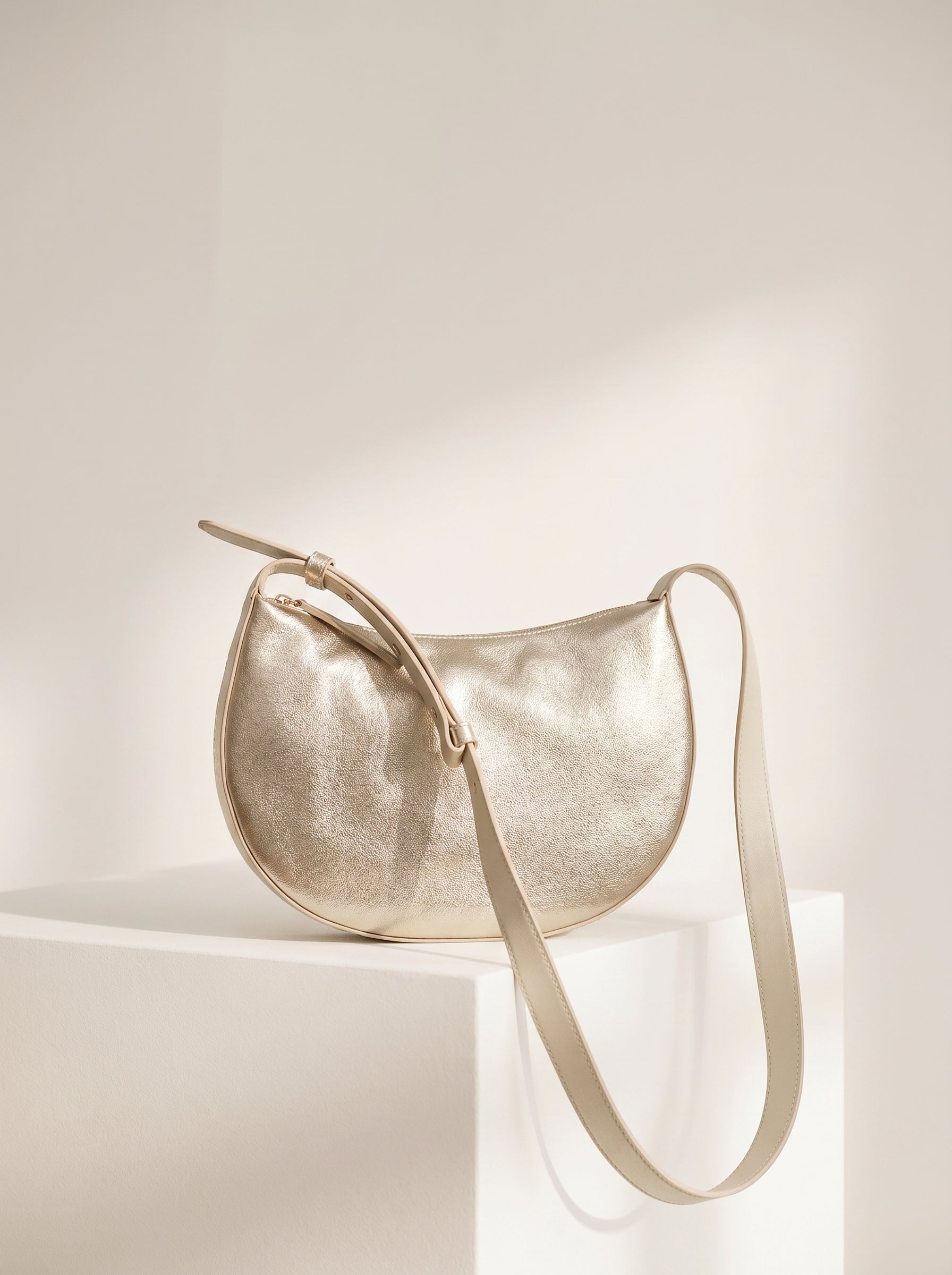 Nanso OLKA KUU - half moon-shaped leather shoulder bag in gold