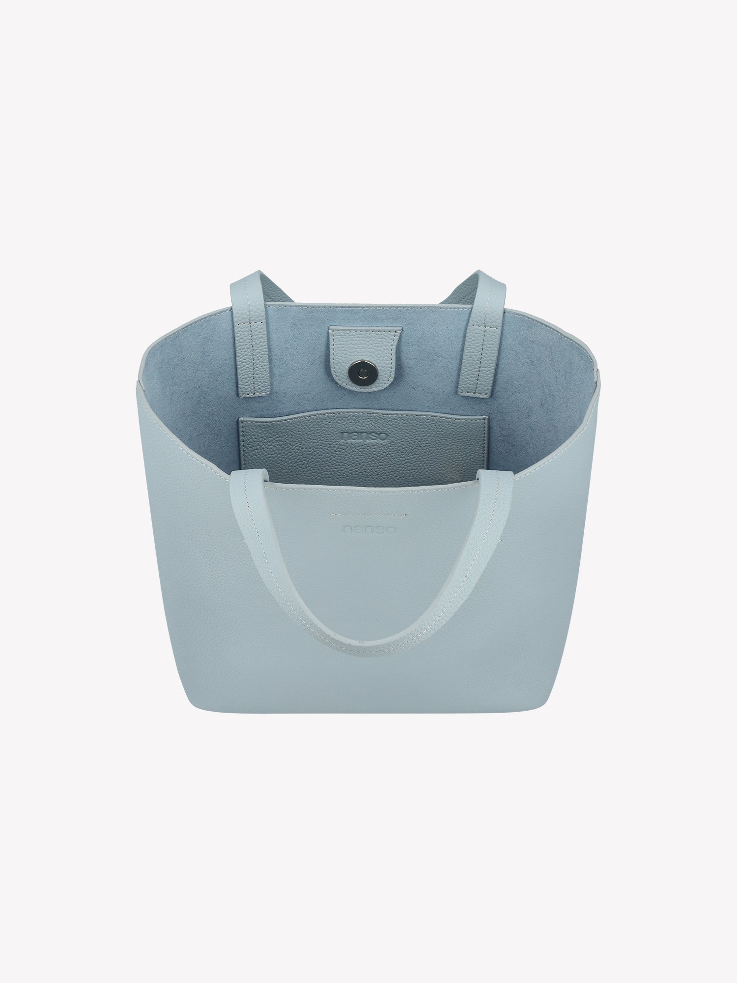 Nanso elegant light blue Naru Tote leather bag. The Naru Tote features both short carry handles and a longer, adjustable and detachable shoulder strap. Product picture from the above without the crossbody strap, with a view to the inside of the bag.
