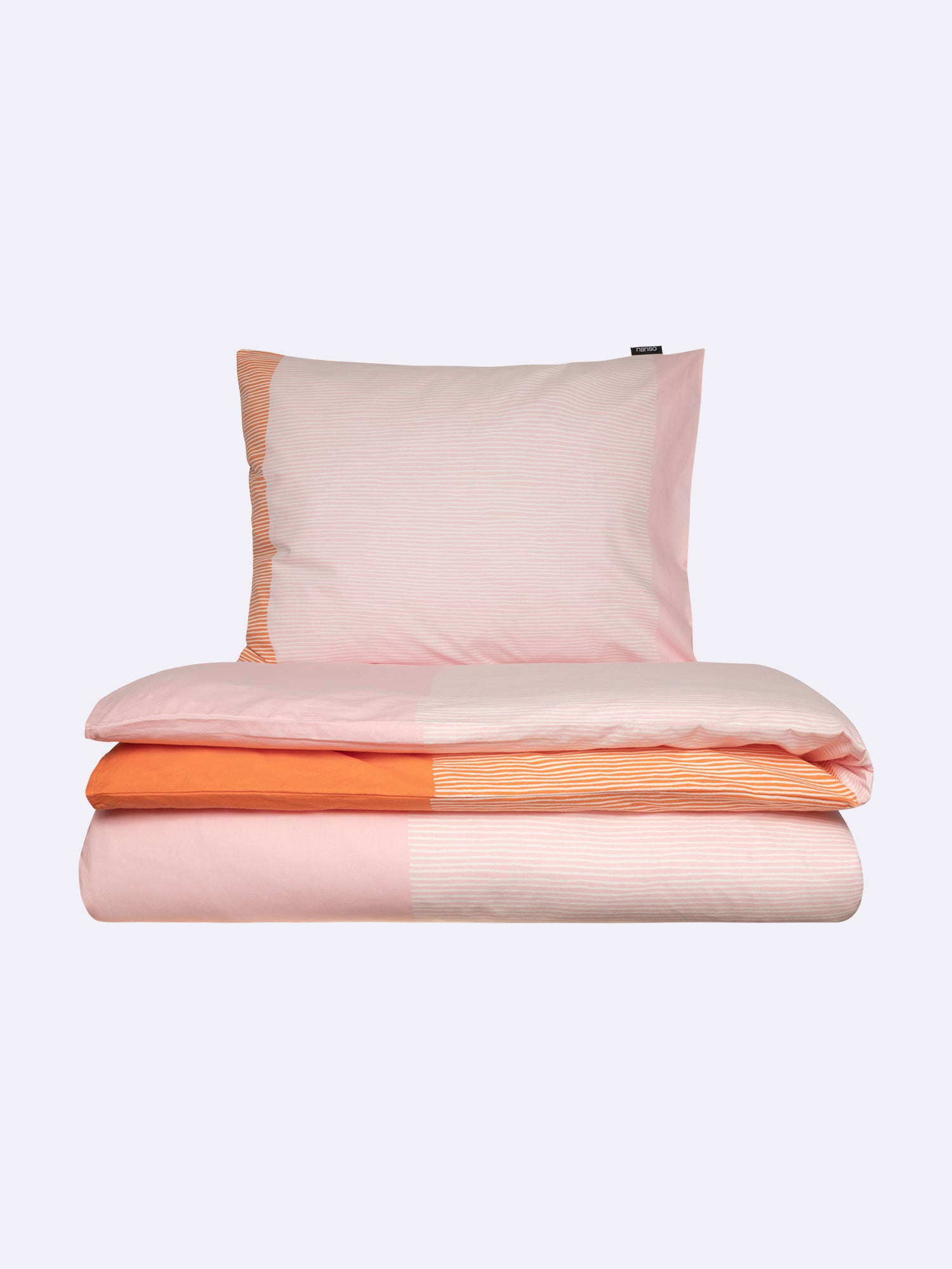 Nanso home's Viiru duvet cover set in orange, folded.