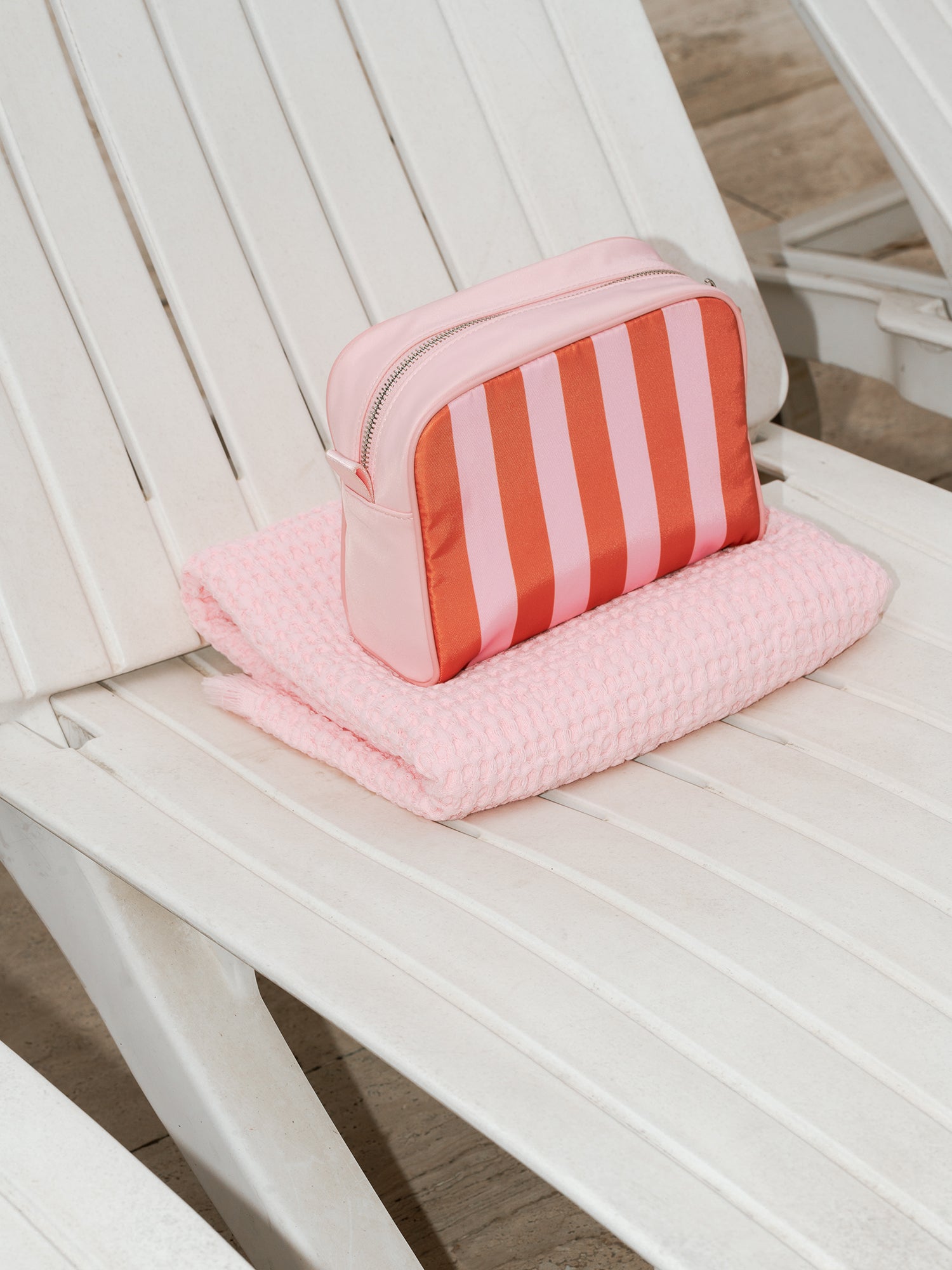 Nanso home's TIE cosmetics bag in orange with stripes from side. 