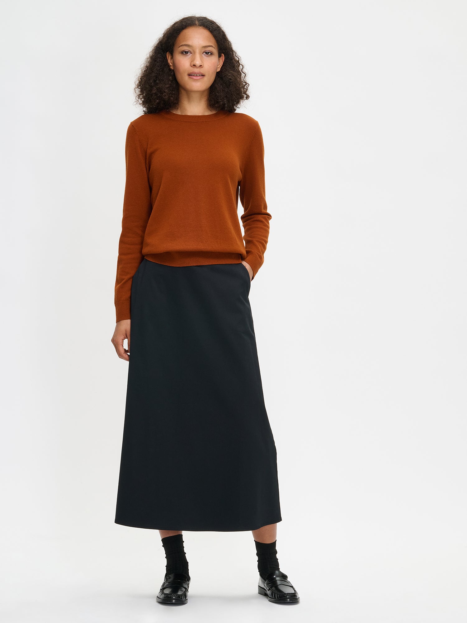 The women's Milla black skirt. Worn by a model.