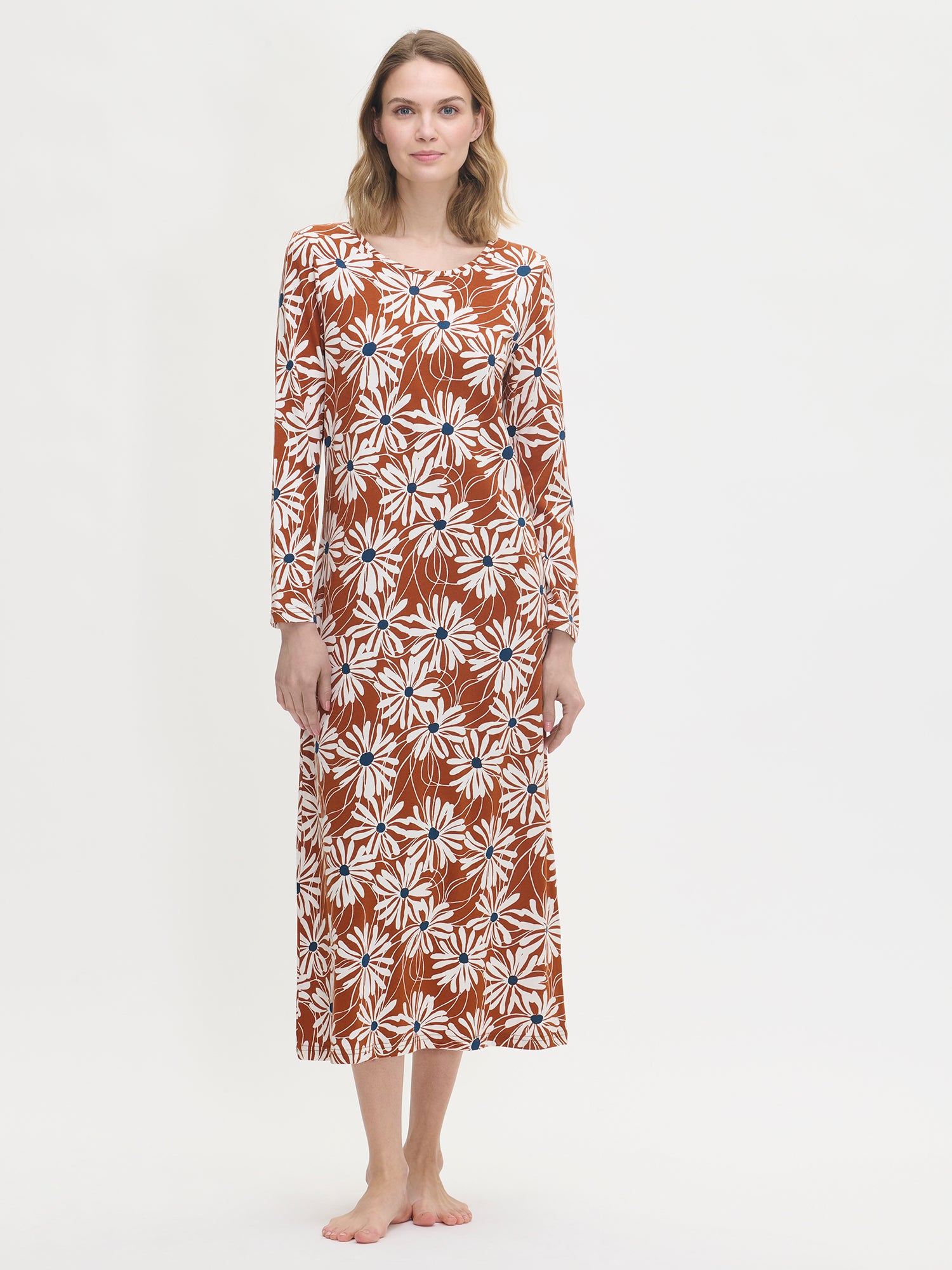 Women’s floral print Anette long nightgown with long sleeves in brown on a model from the front.