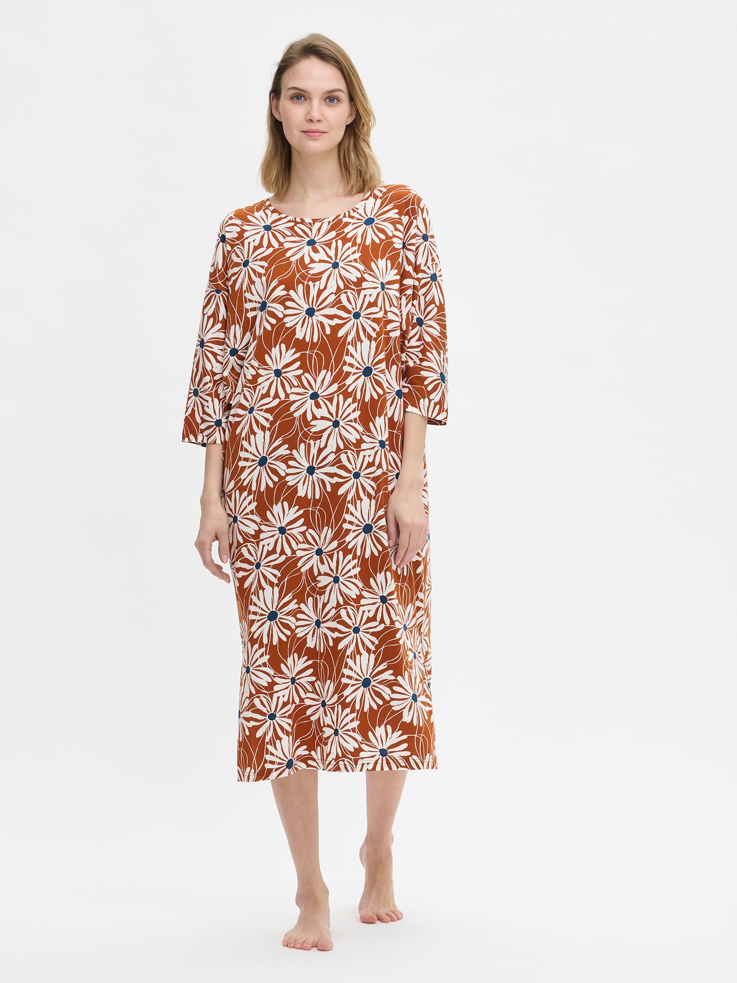 Model wearing a brown floral patterned kaftan on a white background.