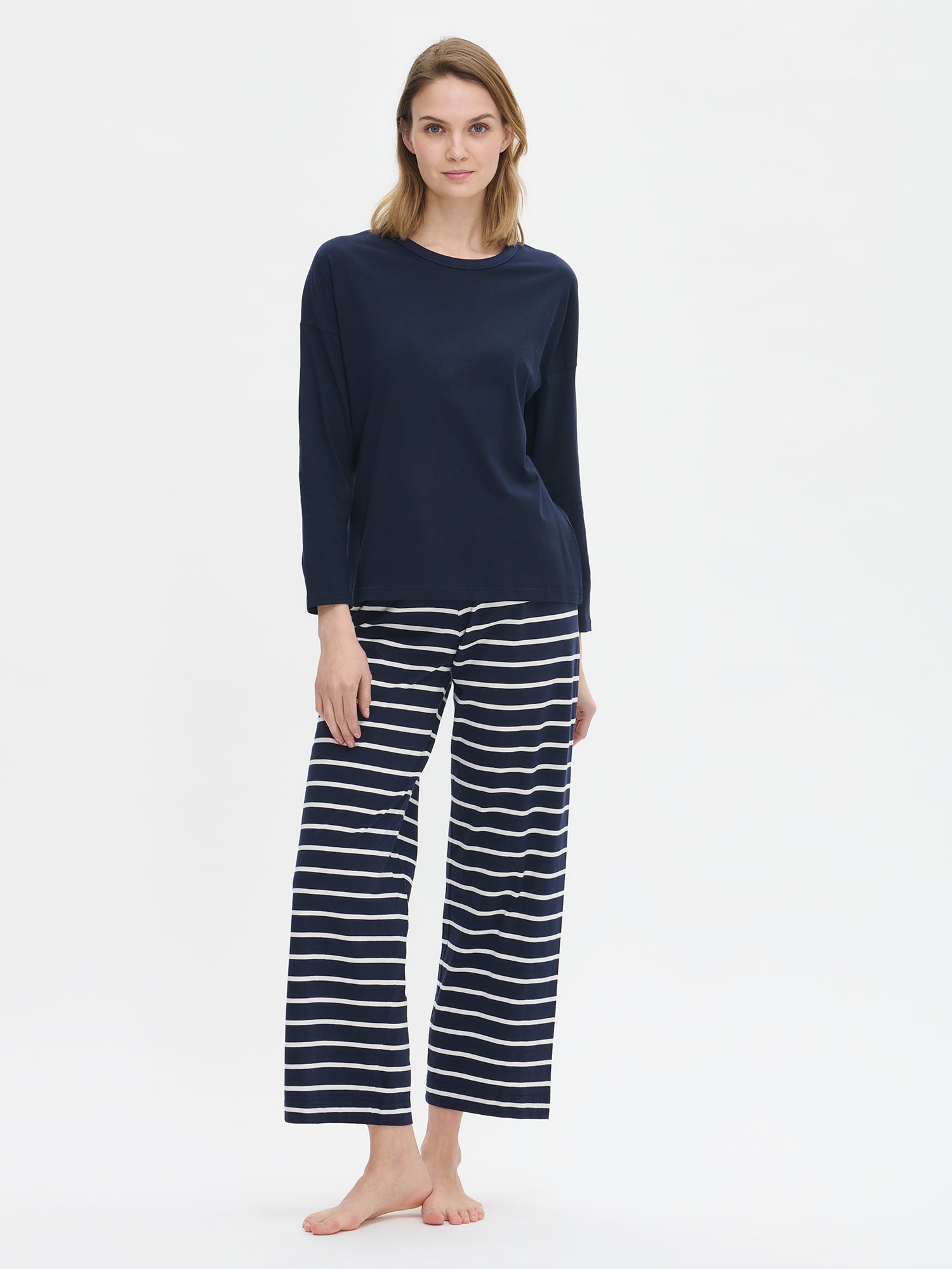 Women's Duetto pants in blue with white stripes on a model. 