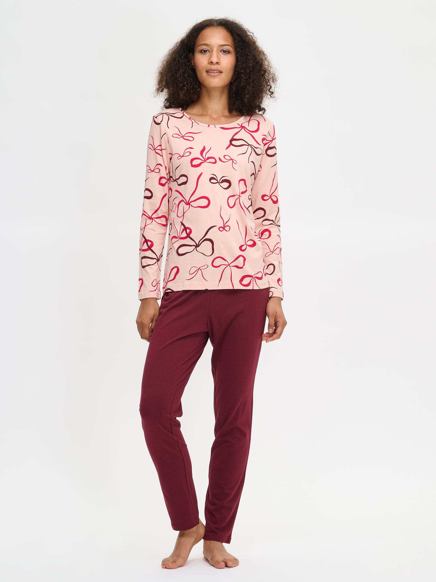 The model has the pink Rusetti pajama set on.