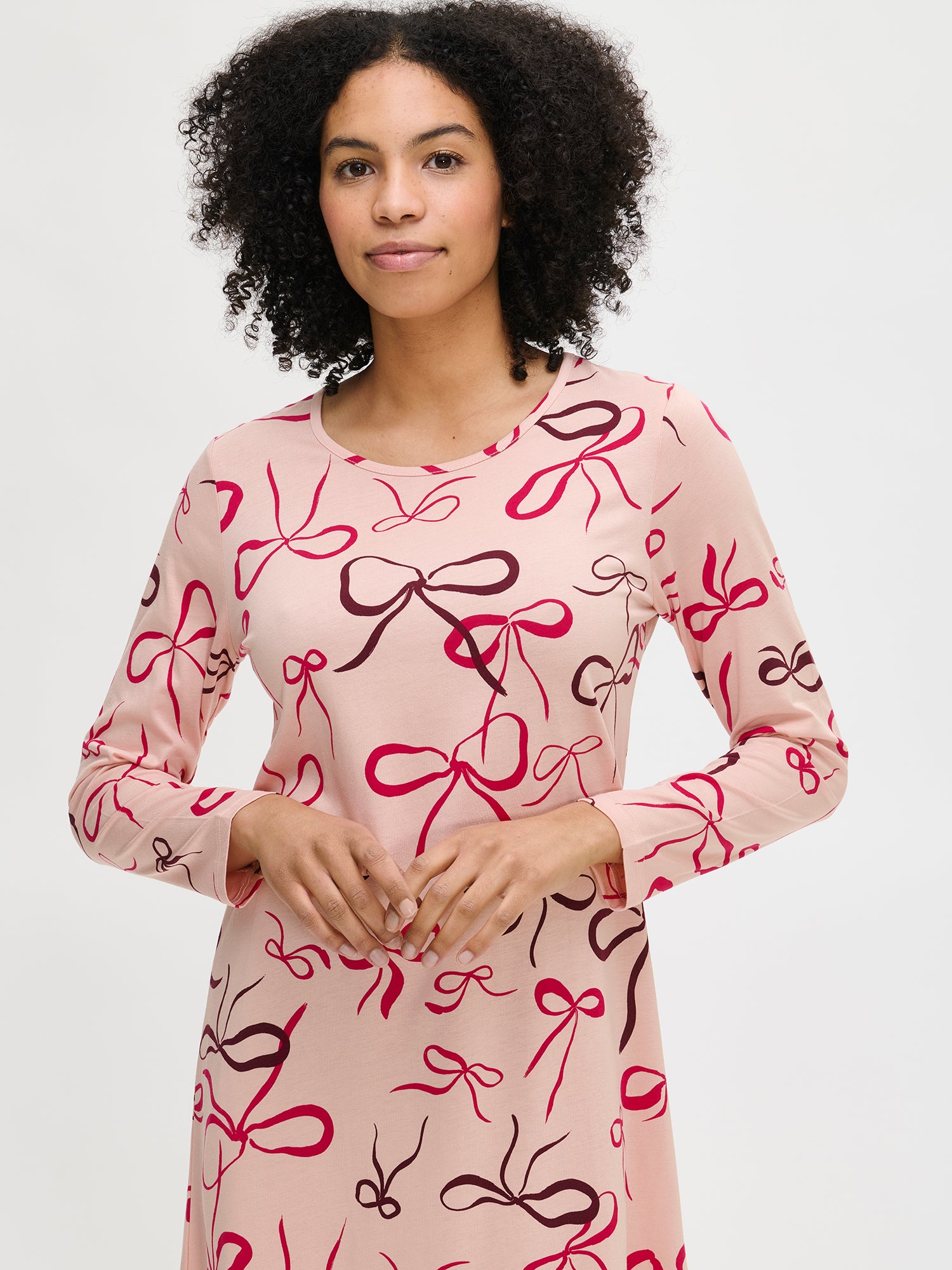 Rusetti nightgown in pink with long sleeves on a model in a close-up photo.