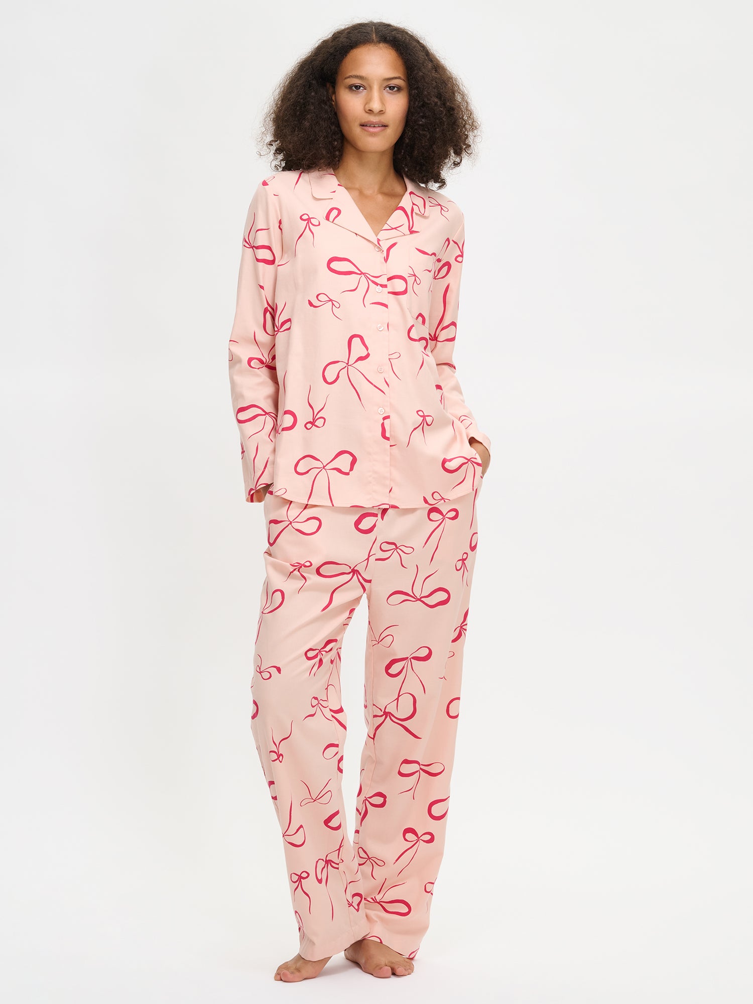 Pink Rusetti pants combined with the same colored Rusetti shirt on a model in the picture.