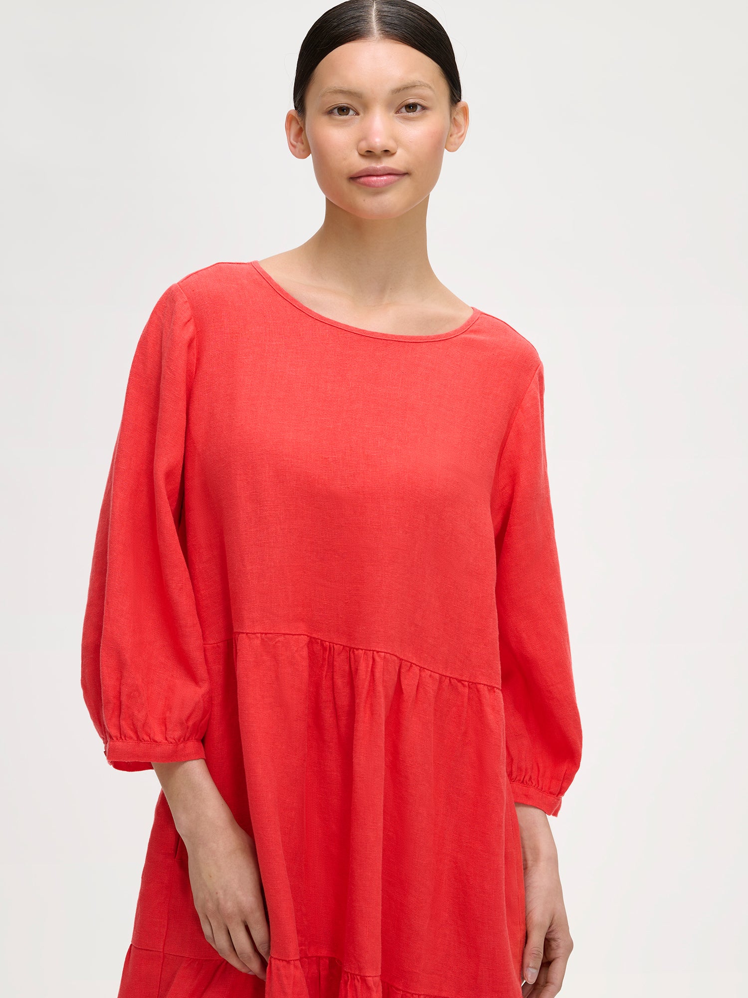 Women's Saralia Linen Dress in red with voluminous frill layers on a model close-up.