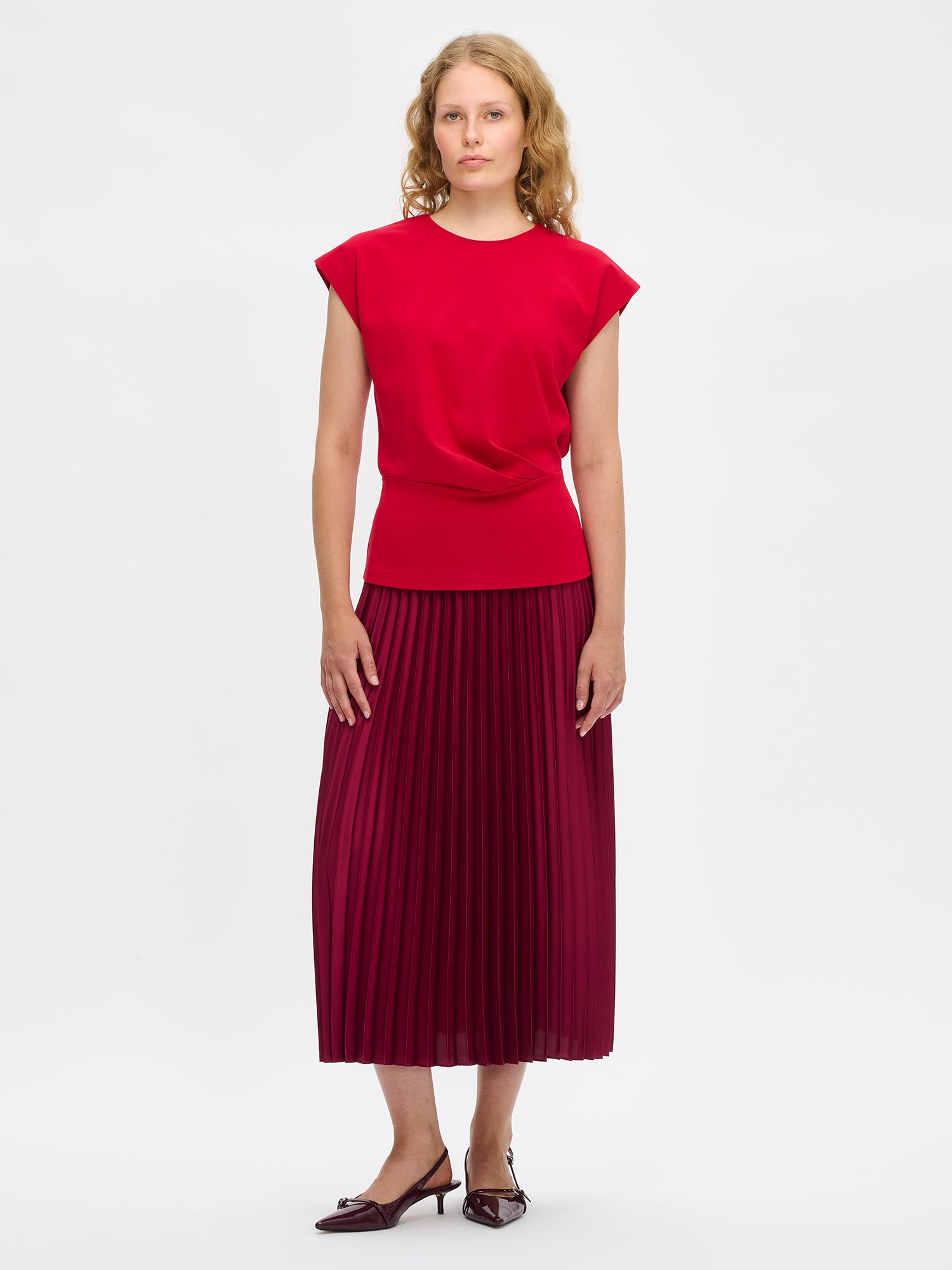 Nanso's elegant Taite skirt for women features a graceful drape in burgundy