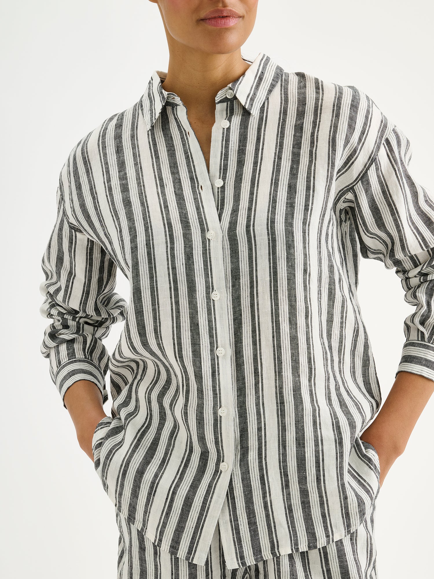 Nanso women's striped black and white Regatta linen shirt on a model, close-up