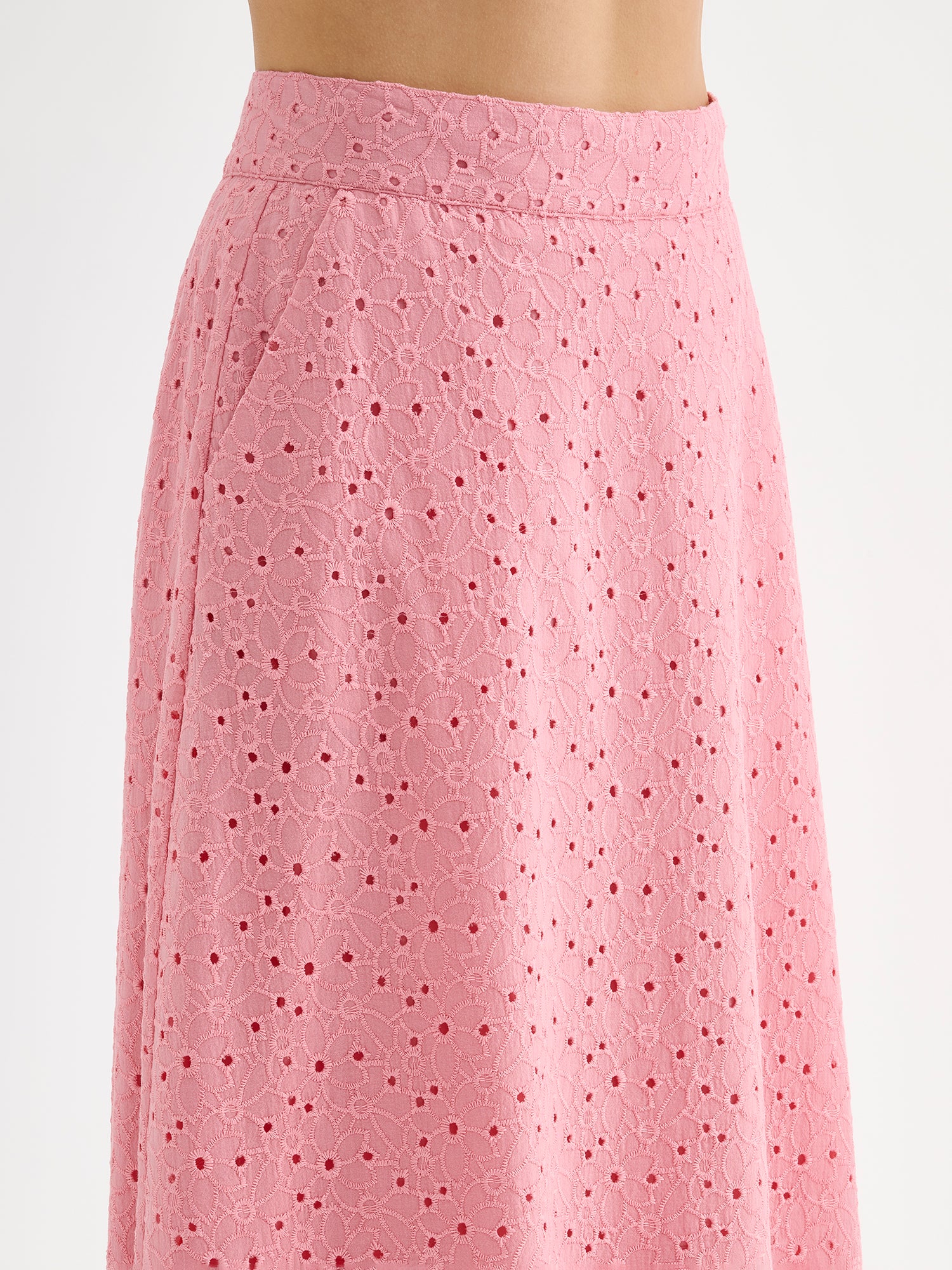 Nanso women's embroidered NUPPU Skirt in light pink featuring a broderie anglais style lace fabric on a model, close up