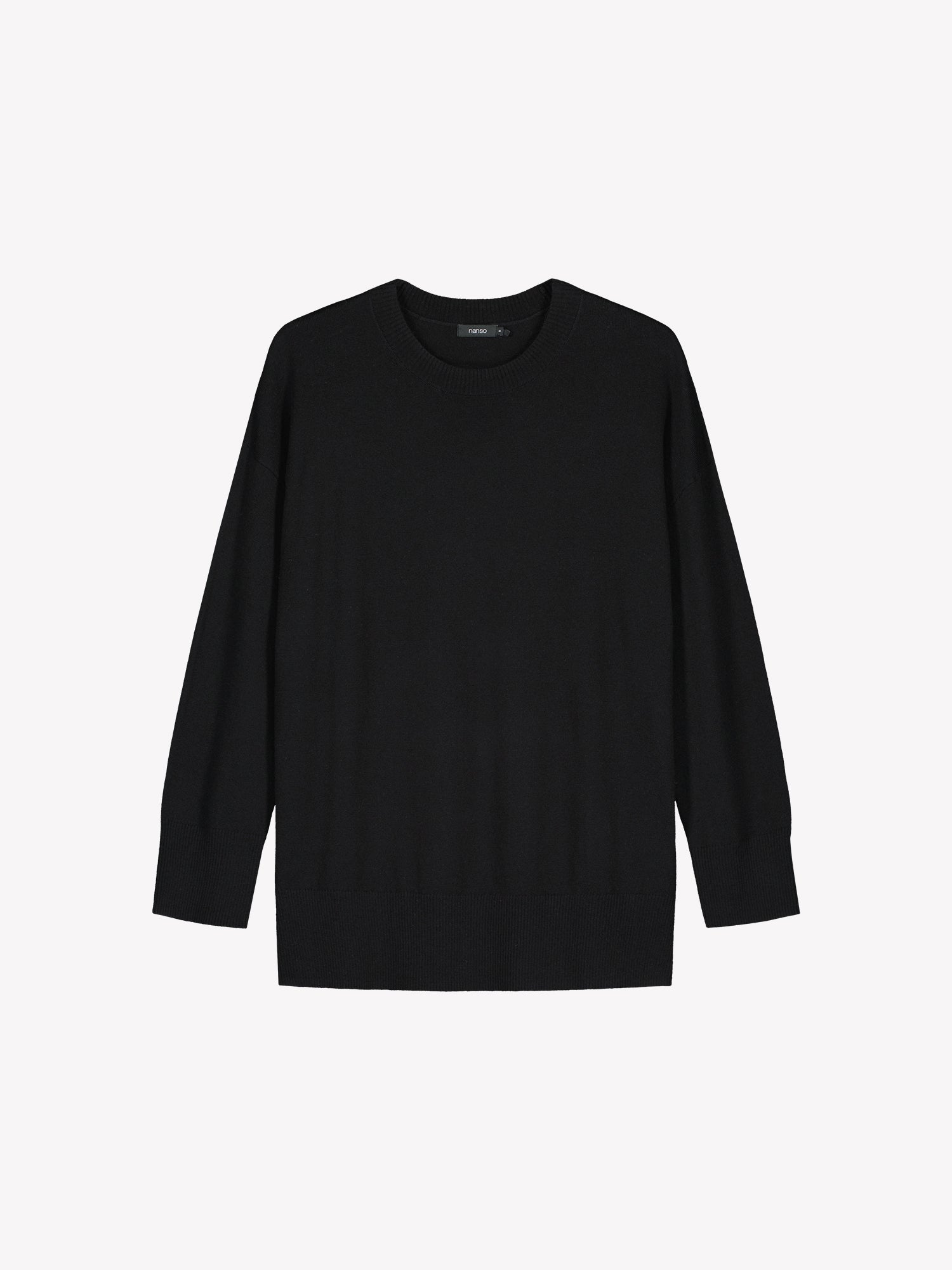 The VILLIS Long Knit Sweater in black features a timeless boxy silhouette and a classic crew neckline, dropped shoulders, and full-length sleeves and ribbed trim at the hem and cuffs. Product picture from the front.