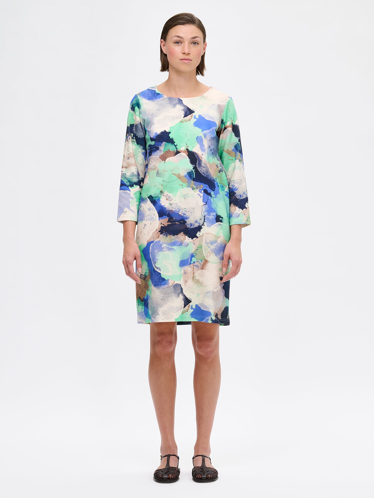 Women's SIRIUS Dress with a beautiful abstract pattern and a clean, minimalist cut that lets the beautiful pattern take center stage. The dress features 3/4 sleeves and pockets. Pictured on a model.