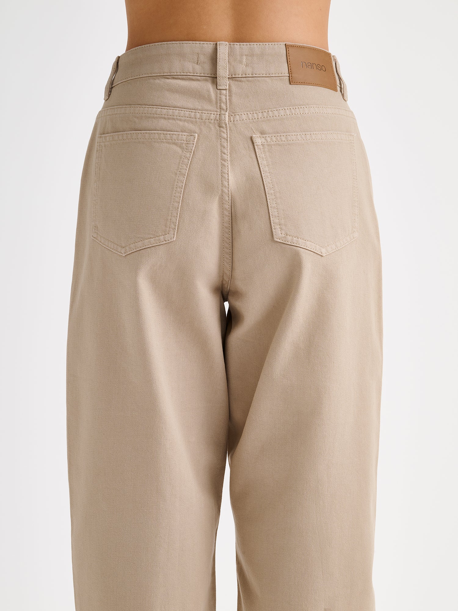 Nanso women's relaxed barrel leg Rento jeans in beige with an effortlessly comfortable fit, on a model, close-up.