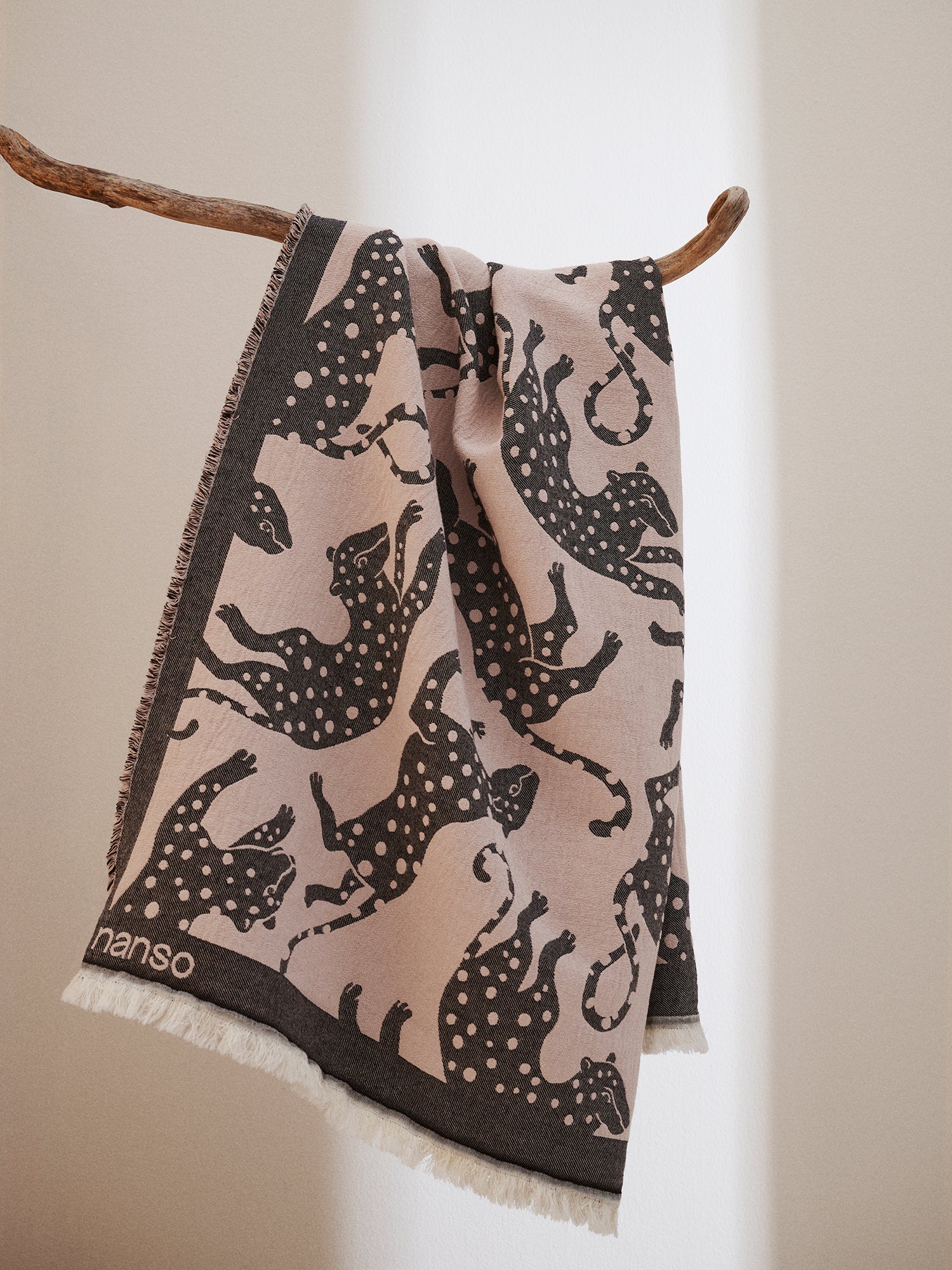 The Leonora blanket placed on a branch.