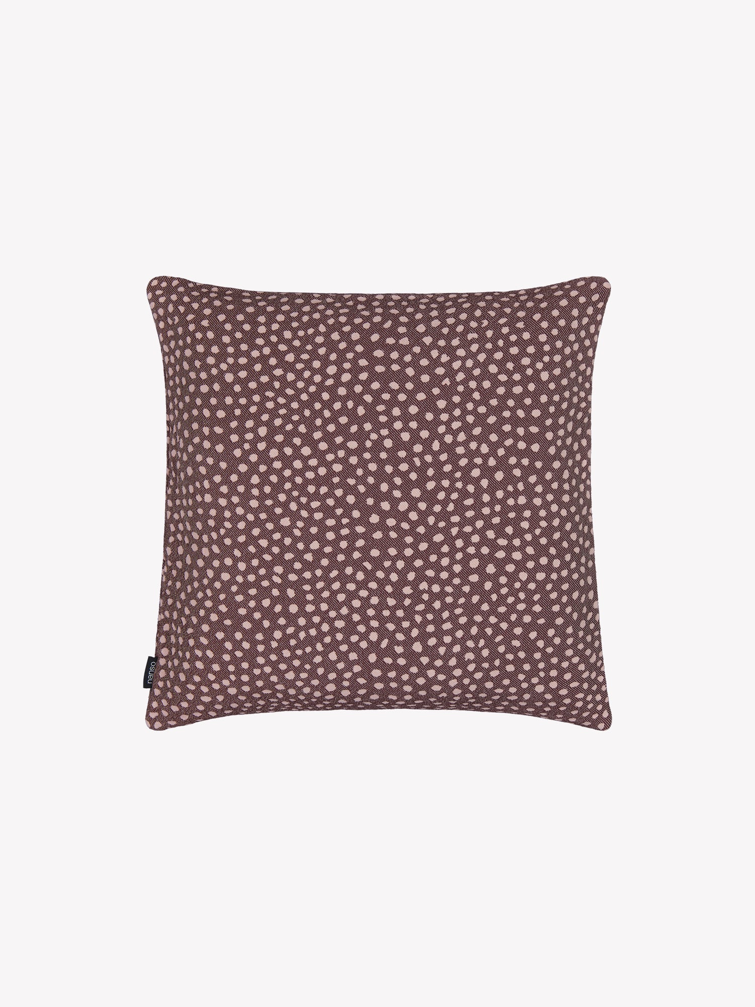 Warm brown Muru pillowcase with polka dots in a product picture.