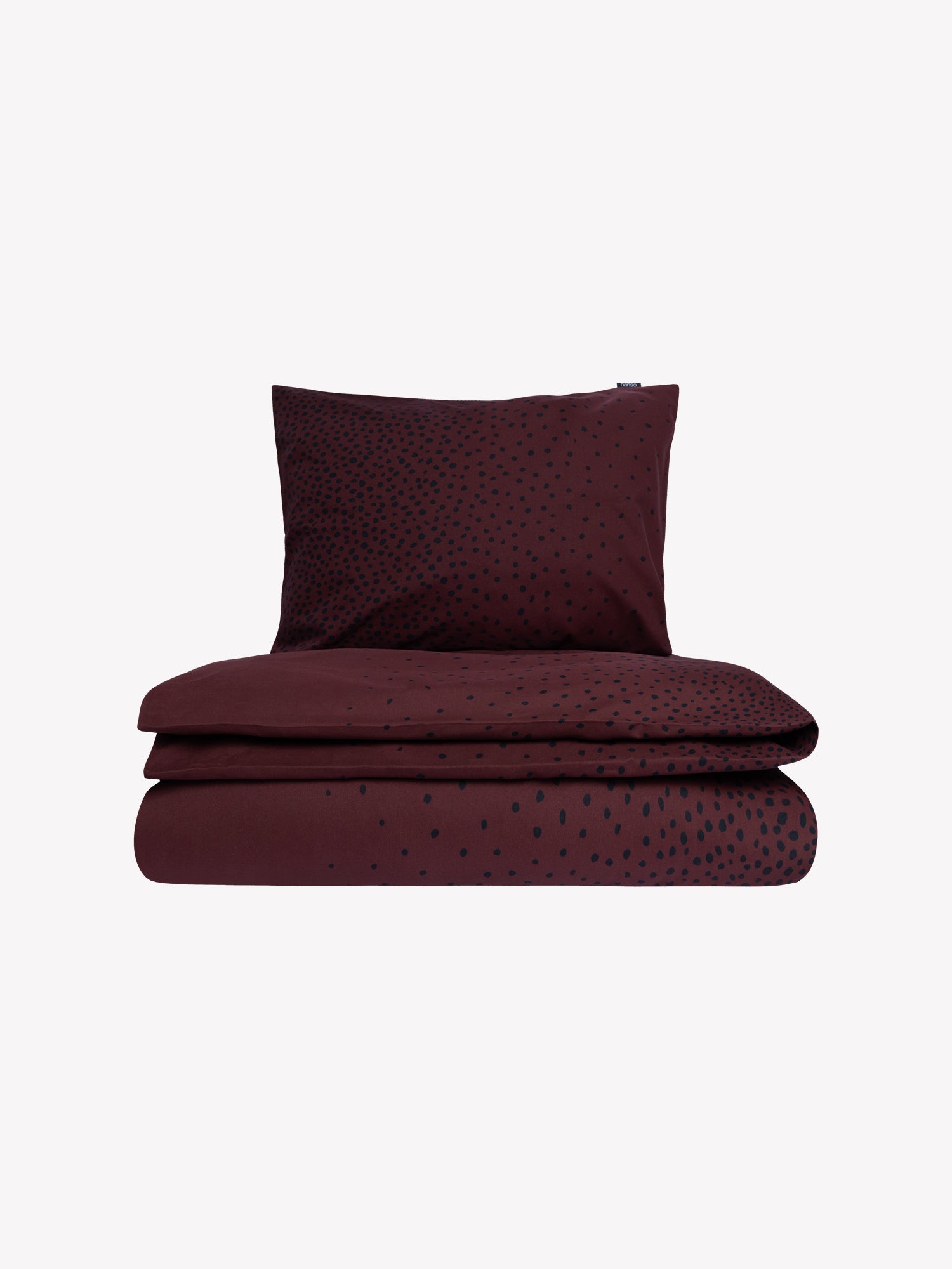 Täplä duvet cover set in brown with charming black dots closed in a product picture.