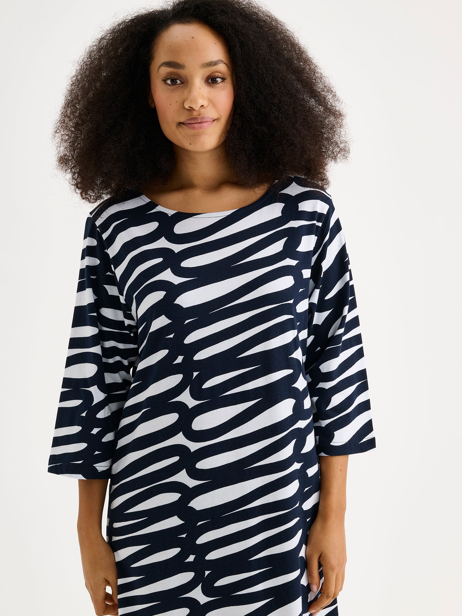 The LUONNOS Long Nightgown features an elegant two-tone print design that combines comfort with contemporary style. Pictured on a model close-up.