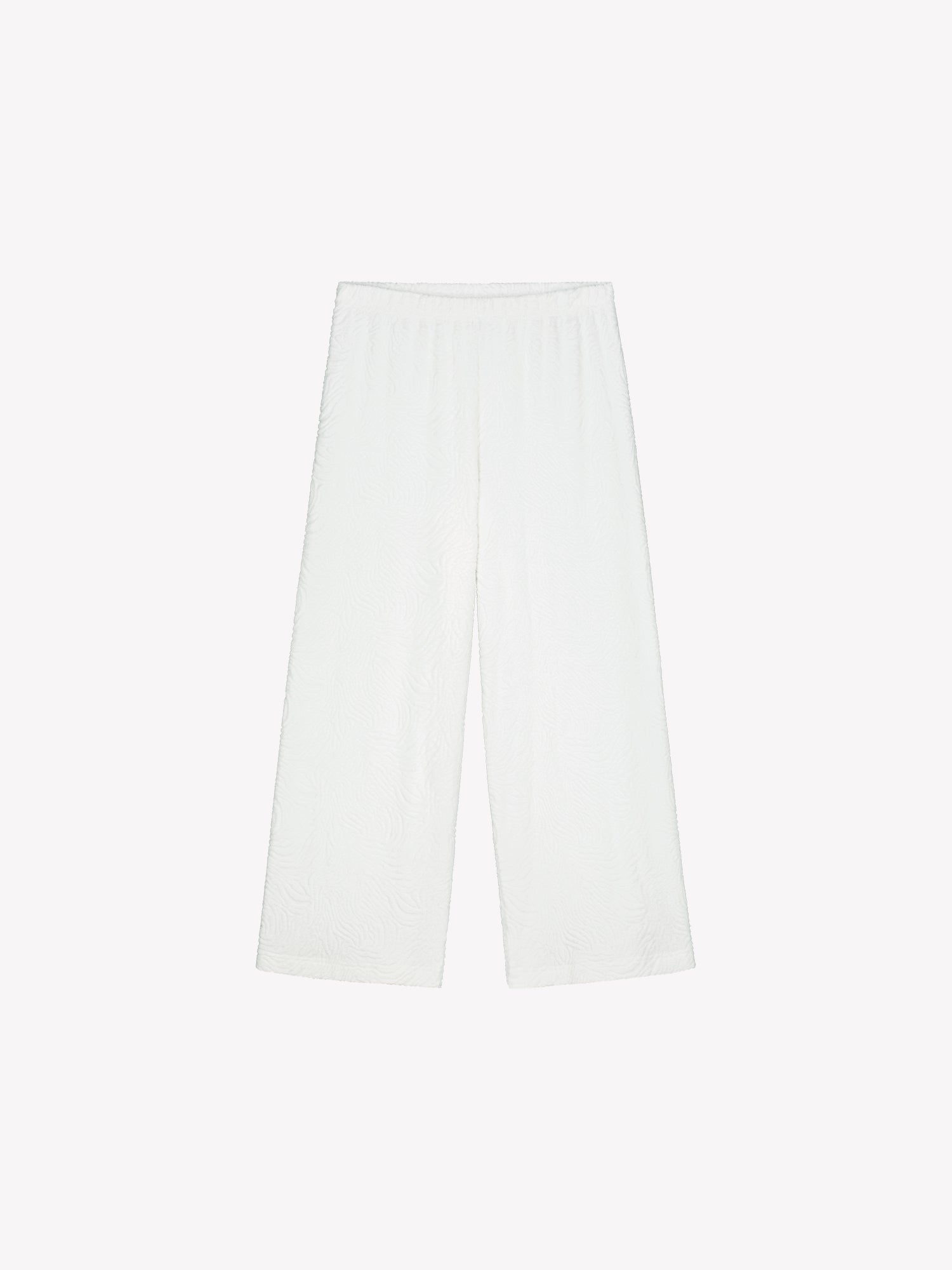 Nanso Väre relaxed-fit lounge pants with a beautifully textured fabric offer full-length coverage with an elastic waistband that provides a comfortable, secure fit throughout the day. Product picture from the front.