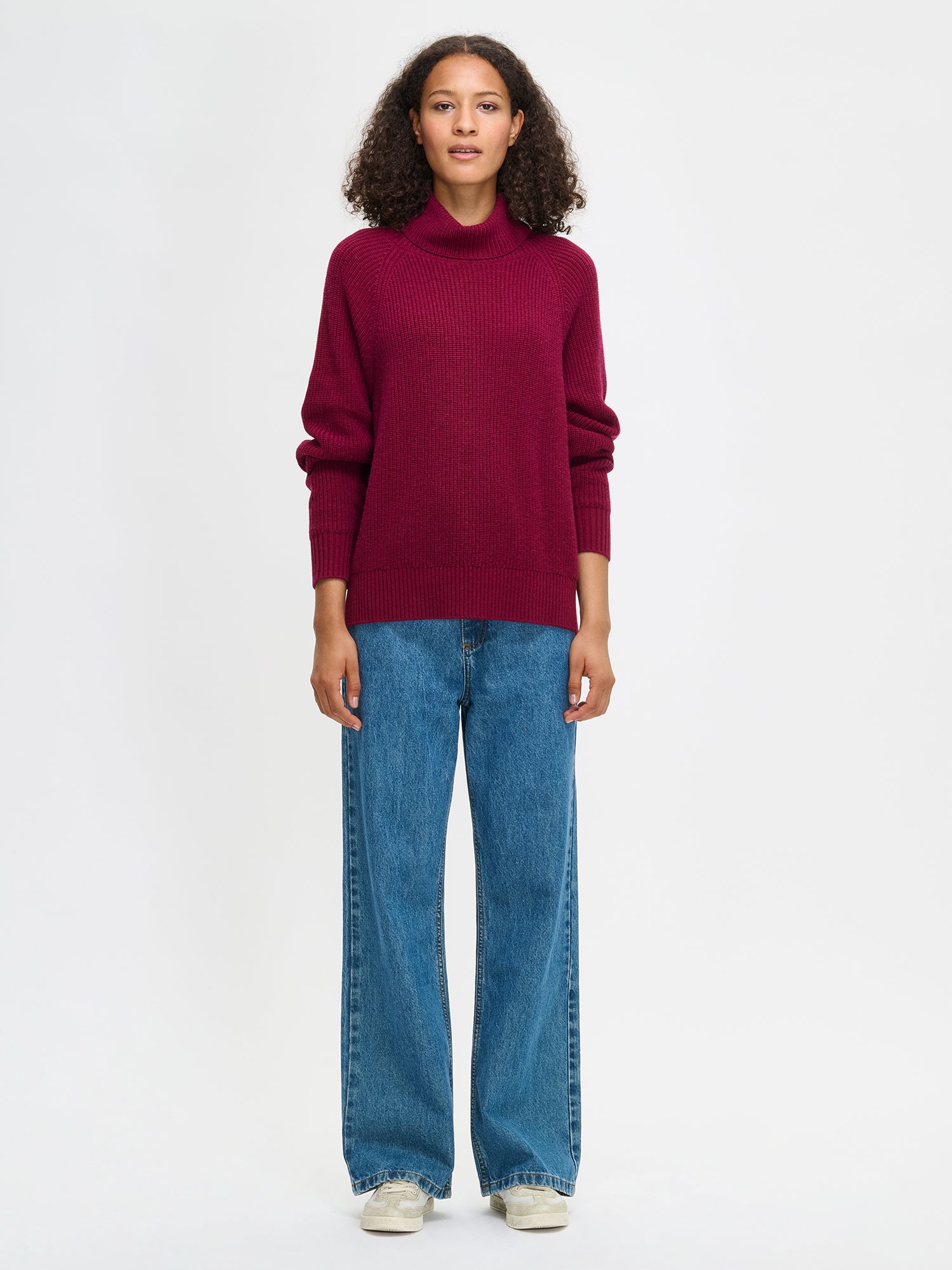 Nanso's Pamela sweater for women is a cozy, burgundy knit featuring a turtleneck and full-length raglan sleeves, front