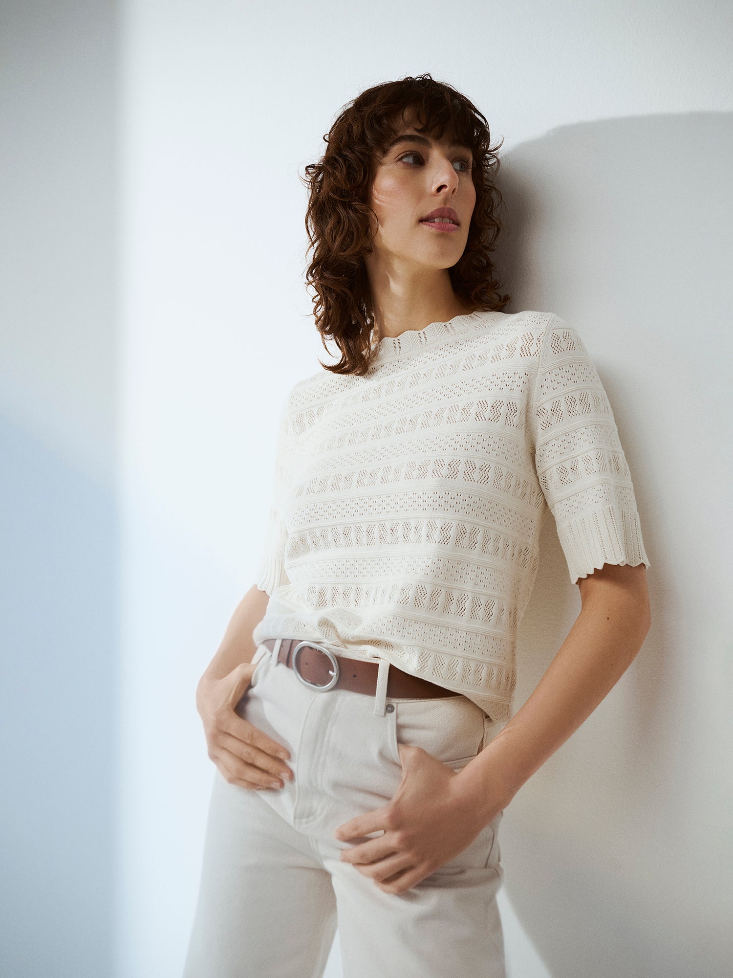 Nanso timeless white KORU knit sweater featuring delicate lace knit that elevates any wardrobe on a model