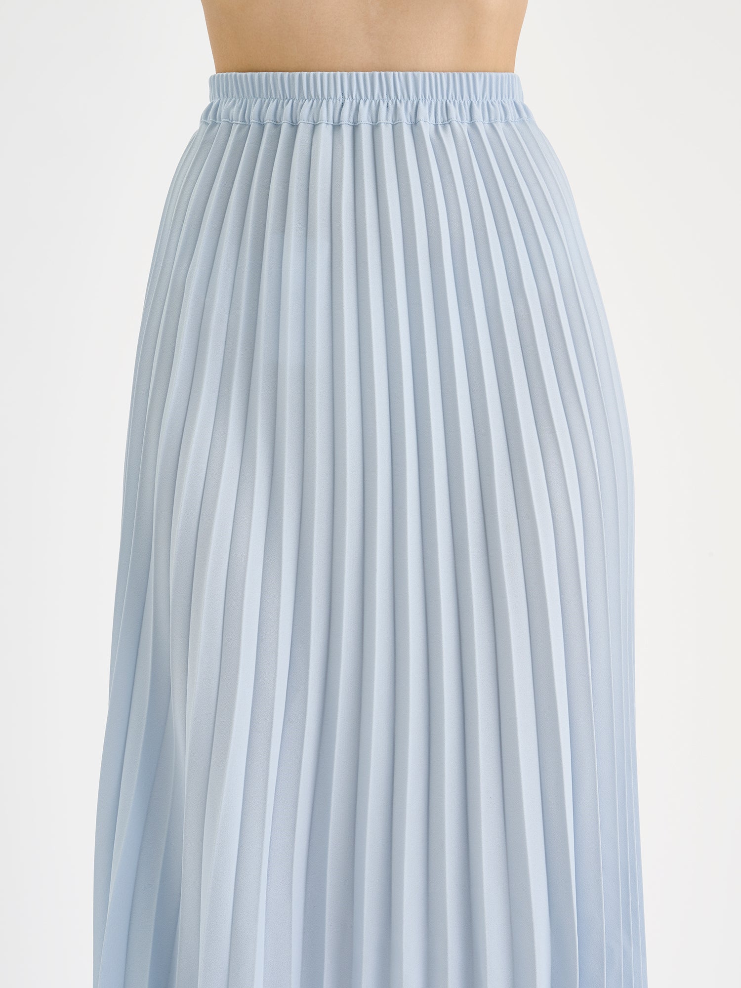 Nanso elegant midi-length ARIEL Skirt in a fresh blue shade on a model , close-up.
