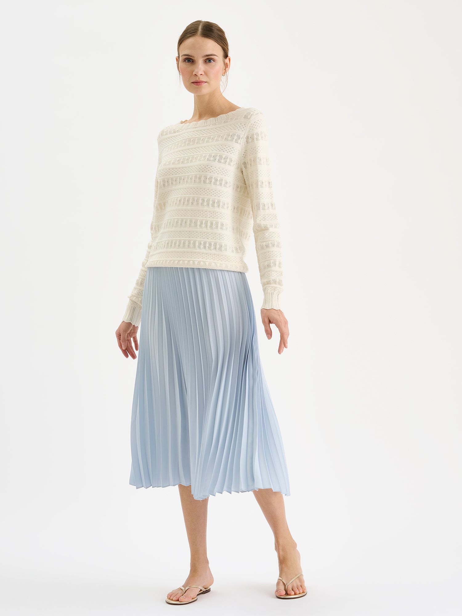 Nanso elegant midi-length ARIEL Skirt in a fresh blue shade on a model with a lace knit sweater.