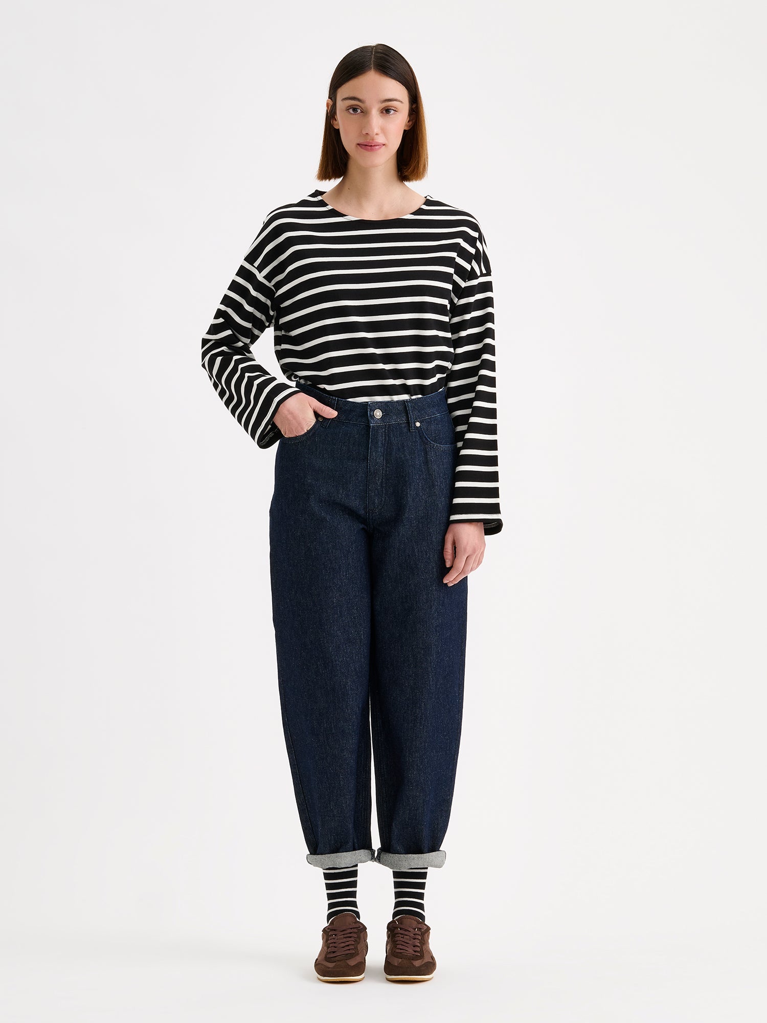 Nanso women's black and white striped long-sleeved Breton blouse with a relaxed, effortless fit, on a model with dark blue jeans.