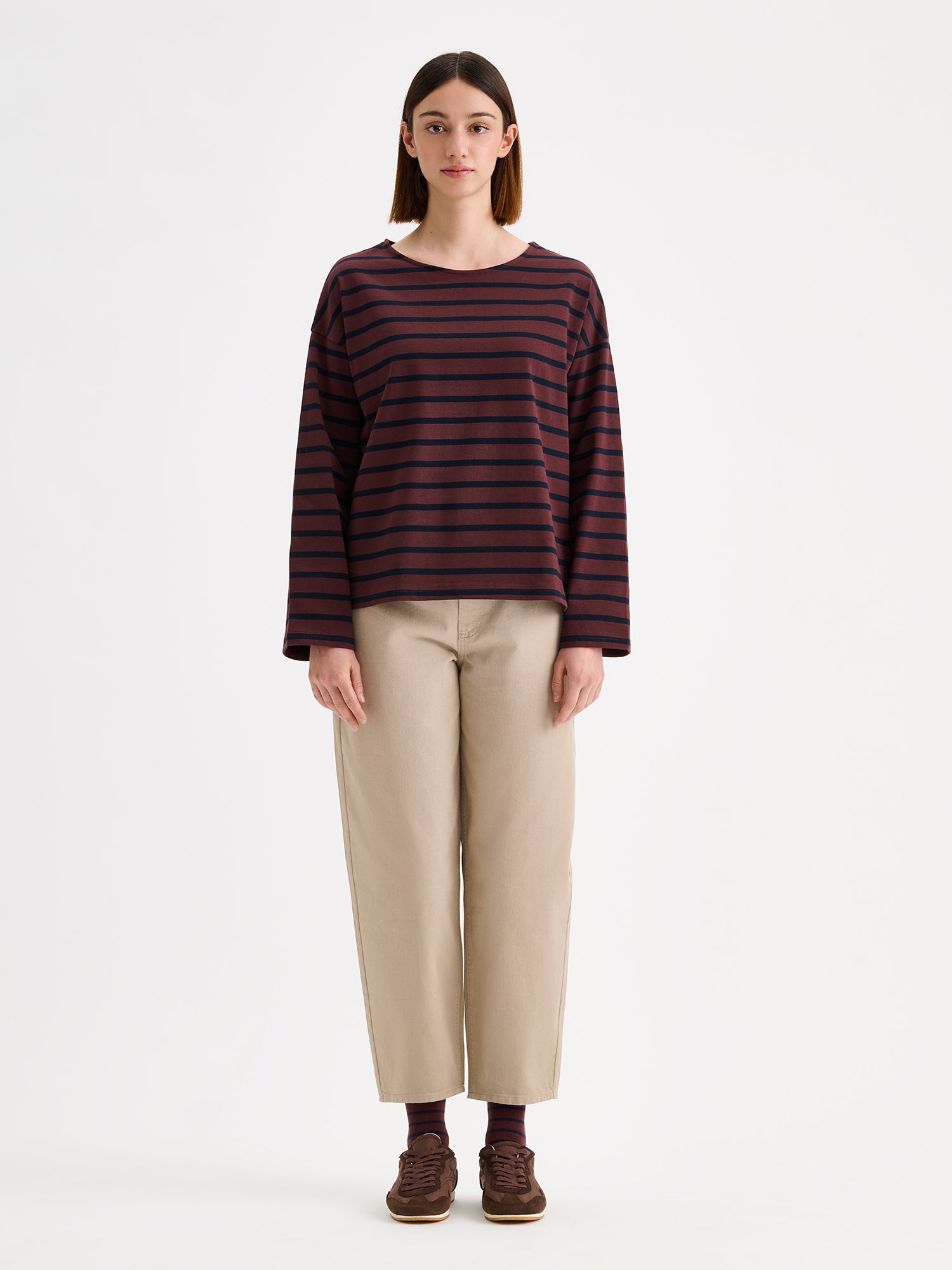 Nanso women's dark brown striped long-sleeved Breton blouse with a relaxed, effortless fit, on a model with beige barrel style jeans.