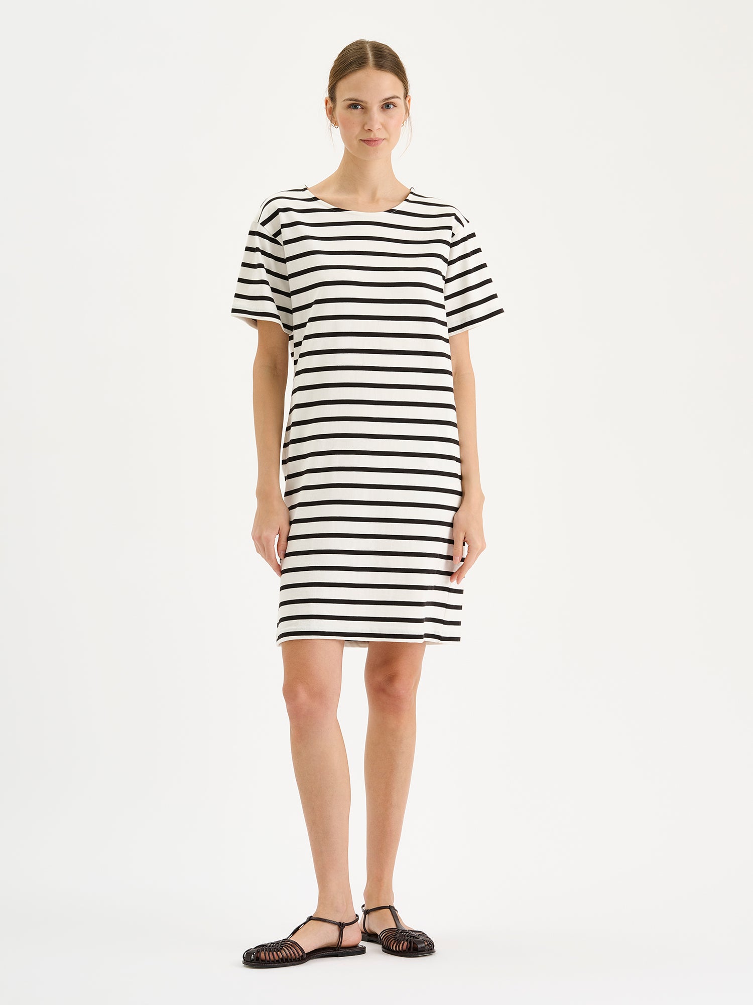 Nanso Breton classic black and white striped T-shirt dress on a model with sandals.