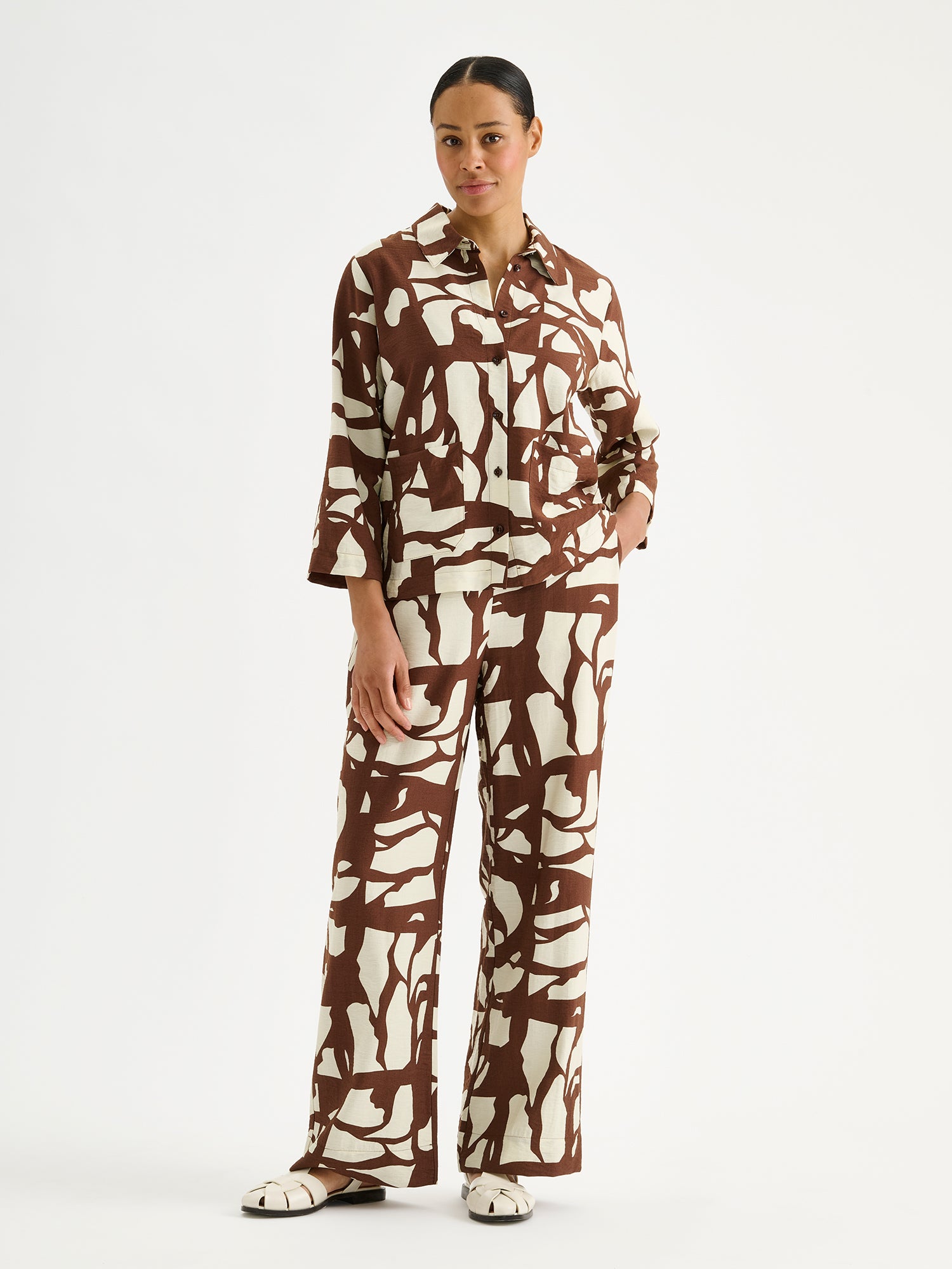 Nanso women's relaxed wide-leg Palsta trousers with side pockets and a stylish two-tone pattern on a model with a matching shirt.