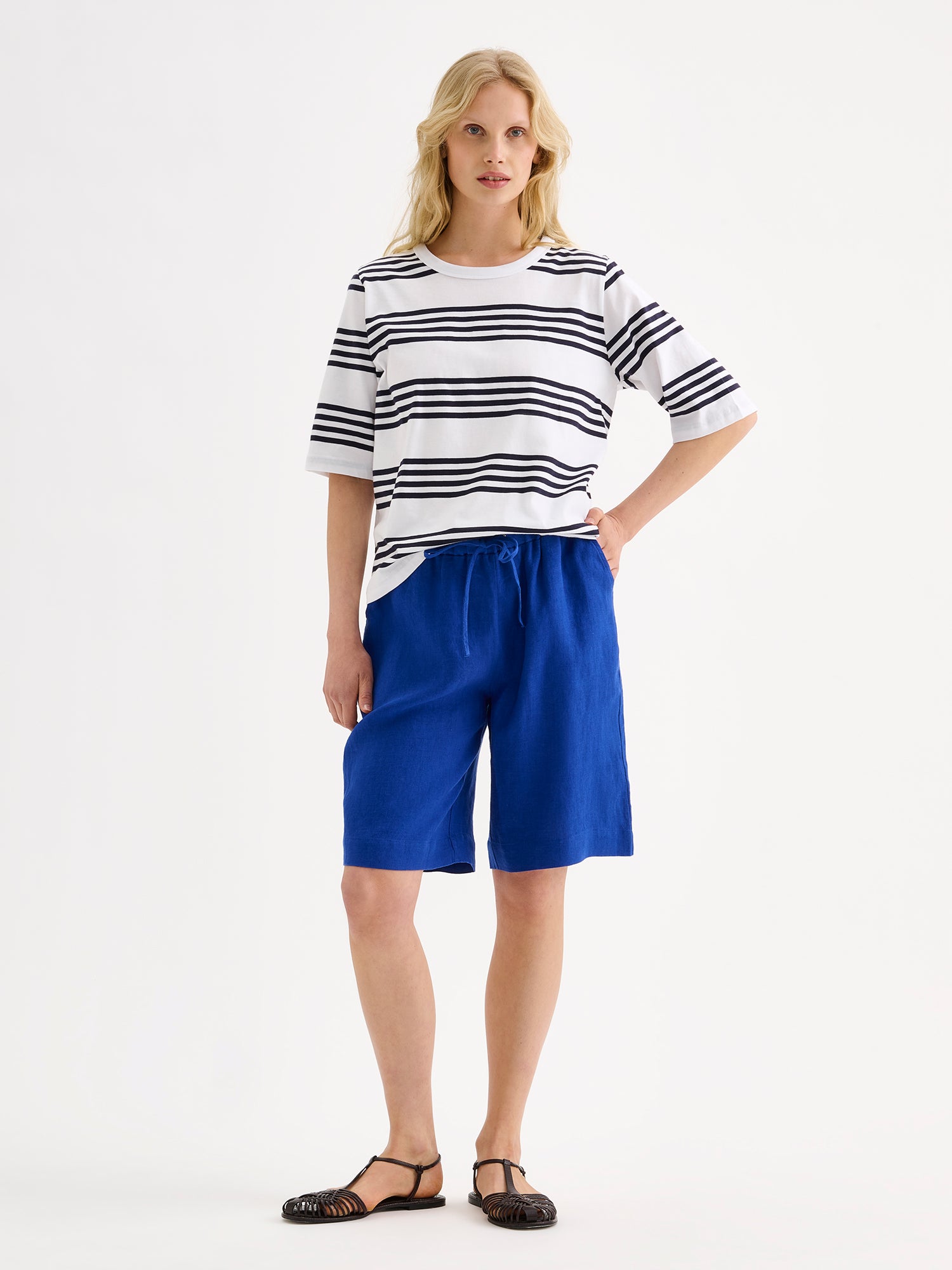 Nanso women's fresh striped navy and white Merina t-shirt on a model with blue shorts