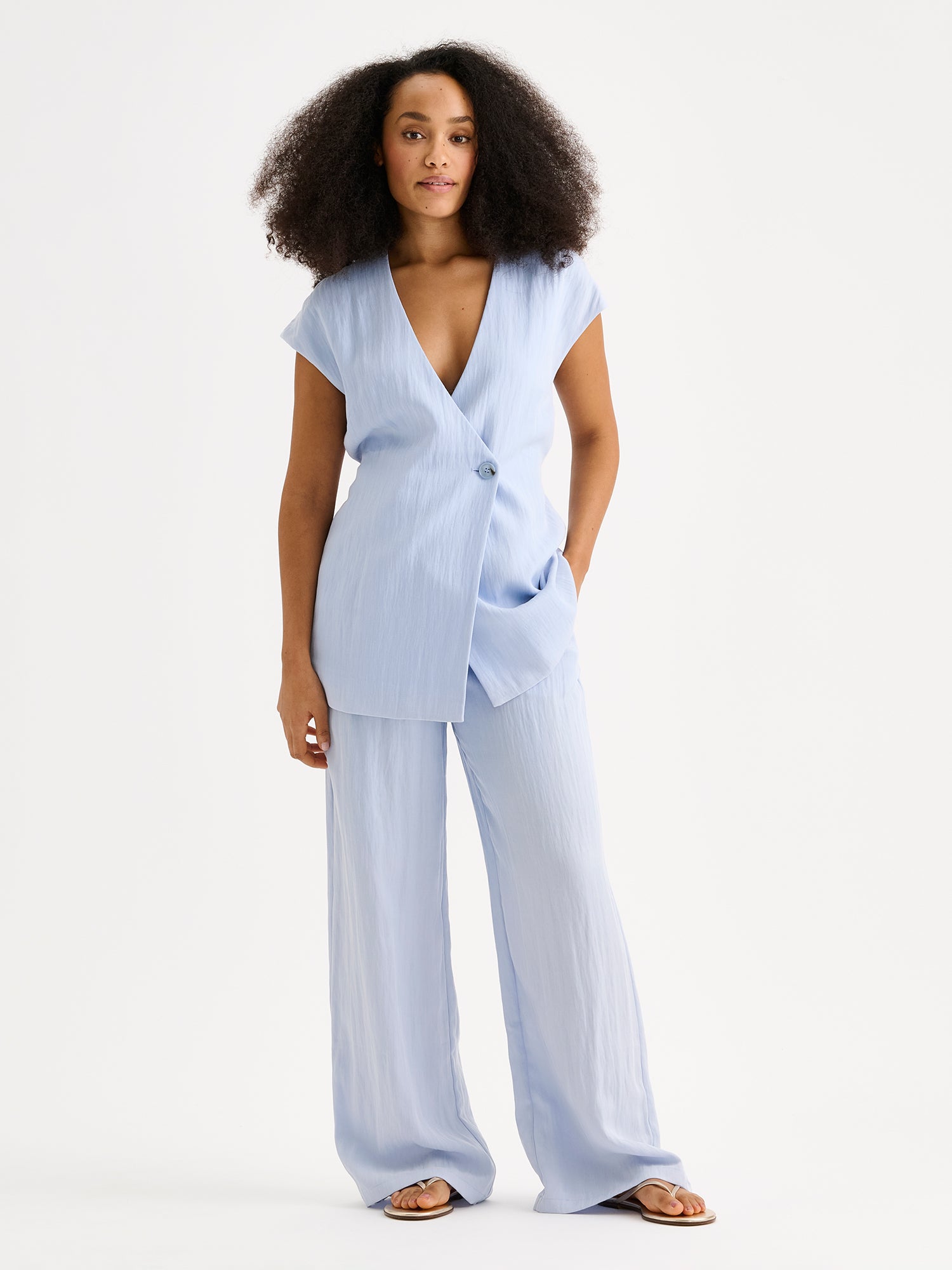 Nanso sophisticated blue waistcoat from the NIZZA collection on a model with matching trousers.