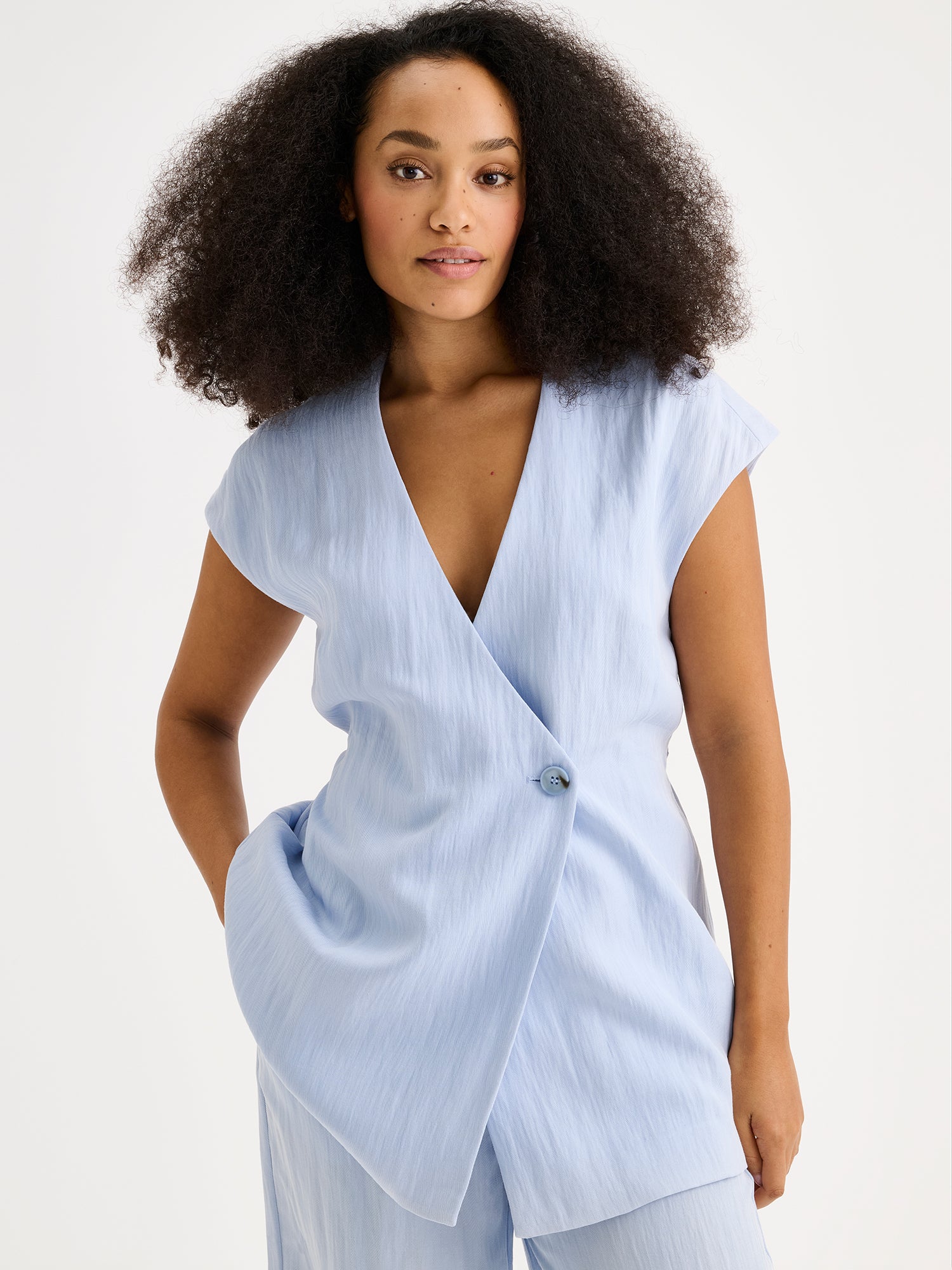 Nanso sophisticated blue waistcoat from the NIZZA collection on a model with matching trousers.