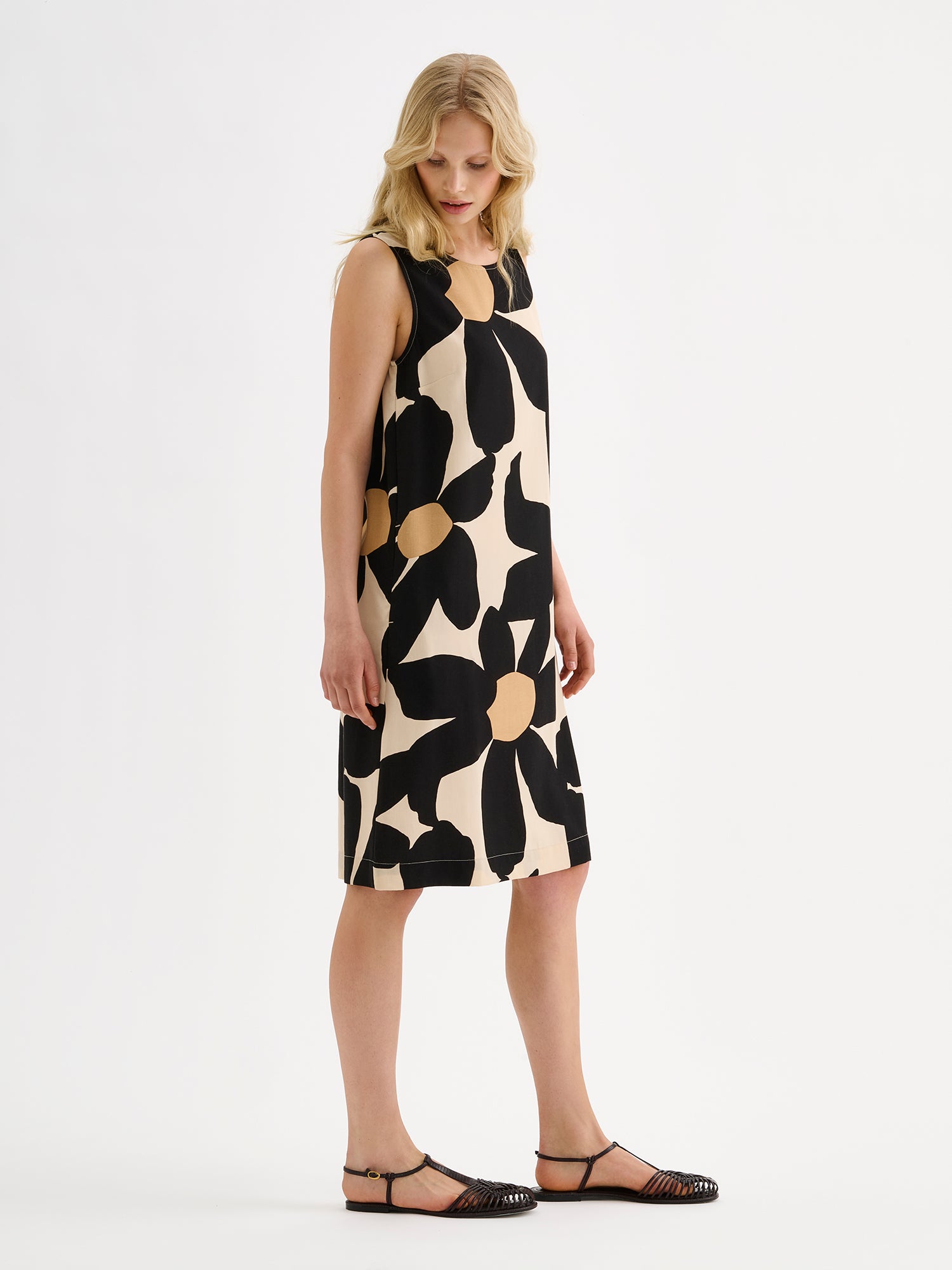 Nanso women's patterned sleeveless ROSI dress on a model with black sandals, pictured from the side