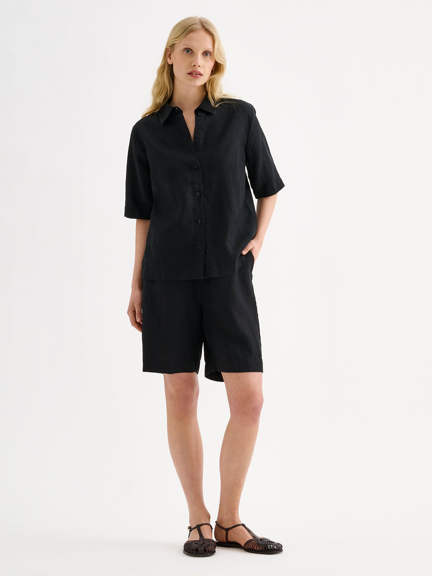 Nanso women's relaxed black Liine linen shirt, crafted from breathable linen on a model with matching shorts.
