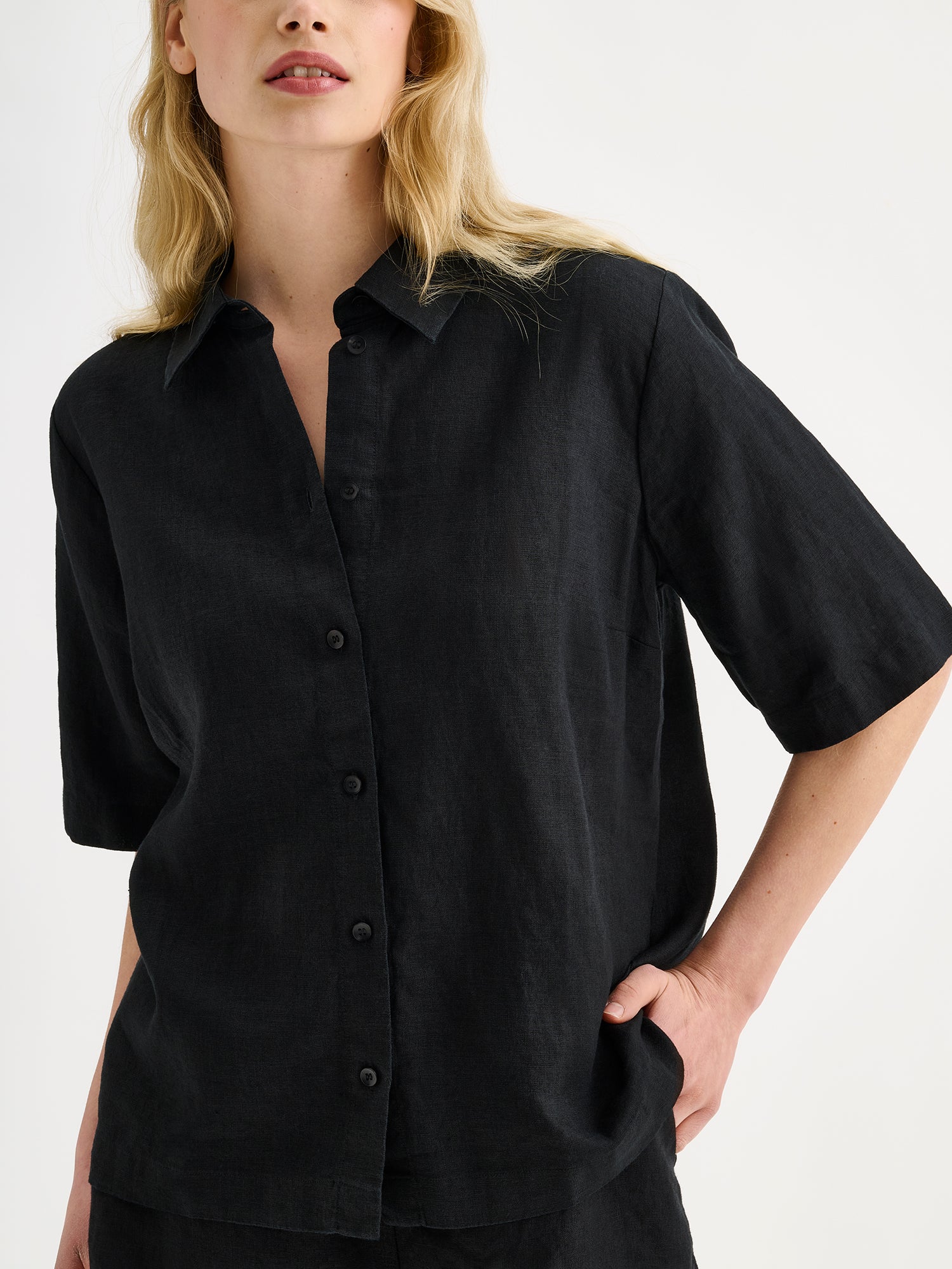 Nanso women's relaxed black Liine linen shirt, crafted from breathable linen on a model with matching shorts, close-up