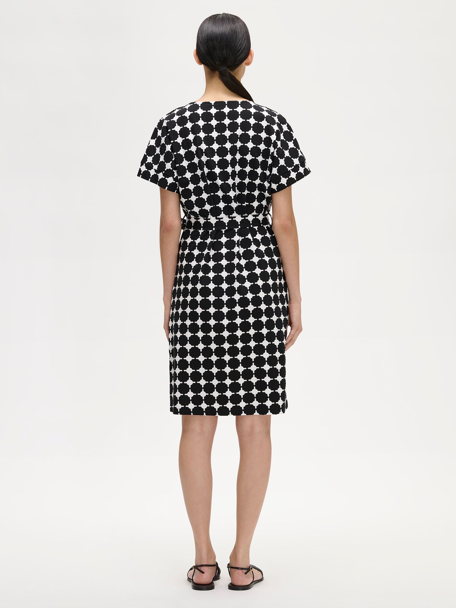 Nanso women's stylish patterned black and white Avene jersey dress for women on a model with sandals, pictured from the backside