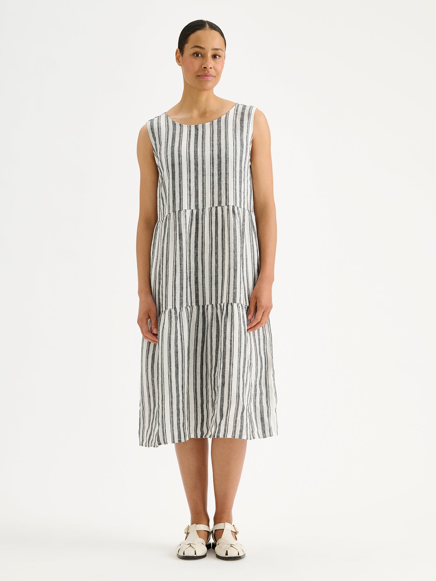 Nanso women's beautifully striped Regatta linen dress with voluminous frill layers is timeless and effortlessly elegant, on a model