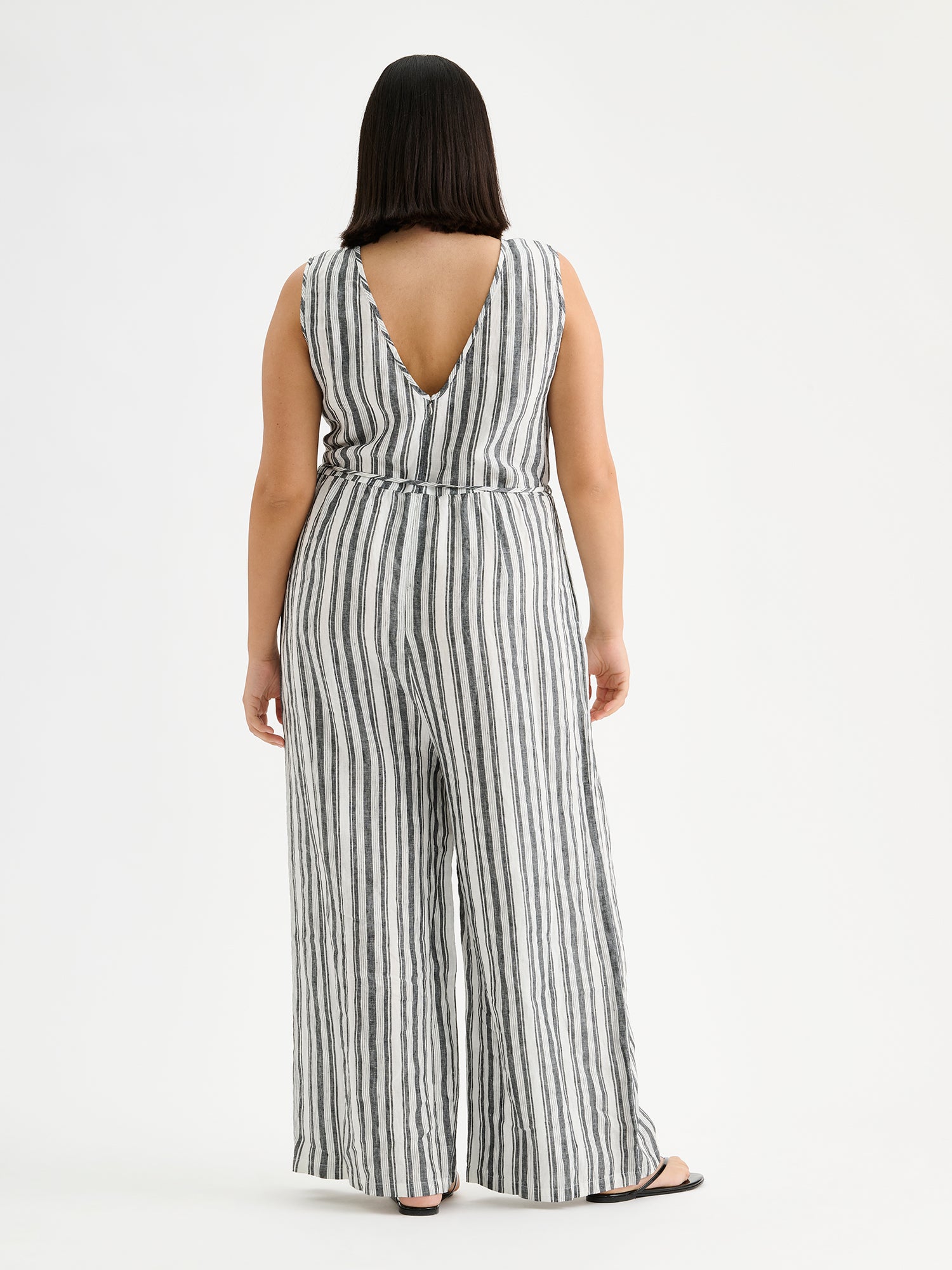 The elegant REGATTA linen jumpsuit with vertical stripes and beautiful cut on a model pictured from the backside