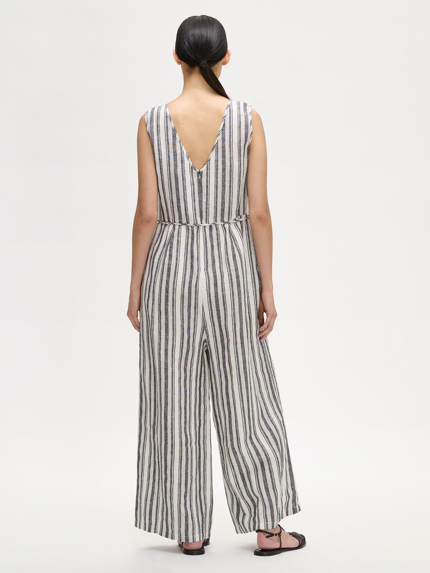 The elegant REGATTA linen jumpsuit with vertical stripes and beautiful cut on a model, picture from the backside