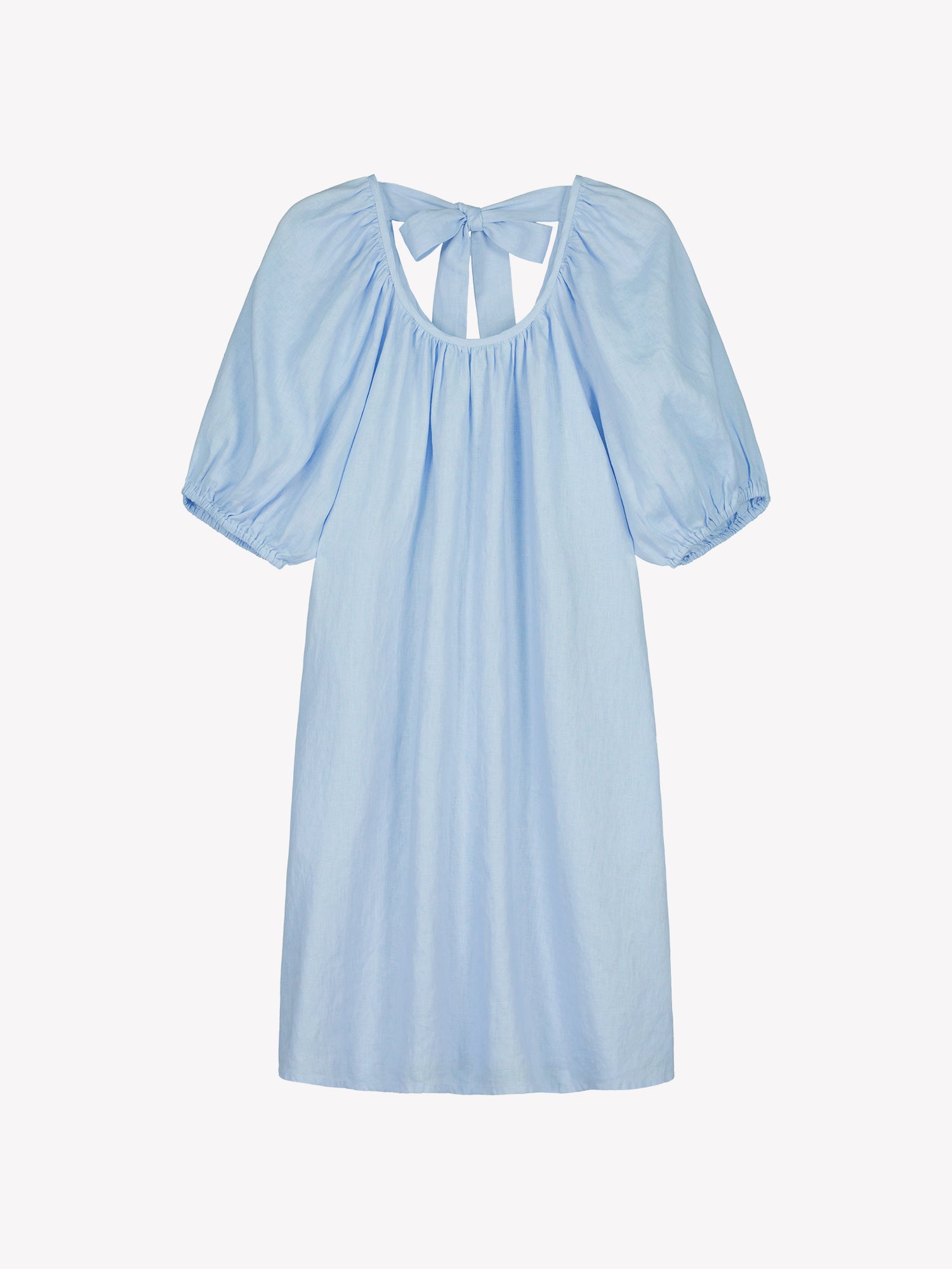 Nanso women’s beautifully relaxed light blue Donna linen dress. This airy short dress features a softly gathered open back neckline, finished with a tie-back bow detail. In a product picture.