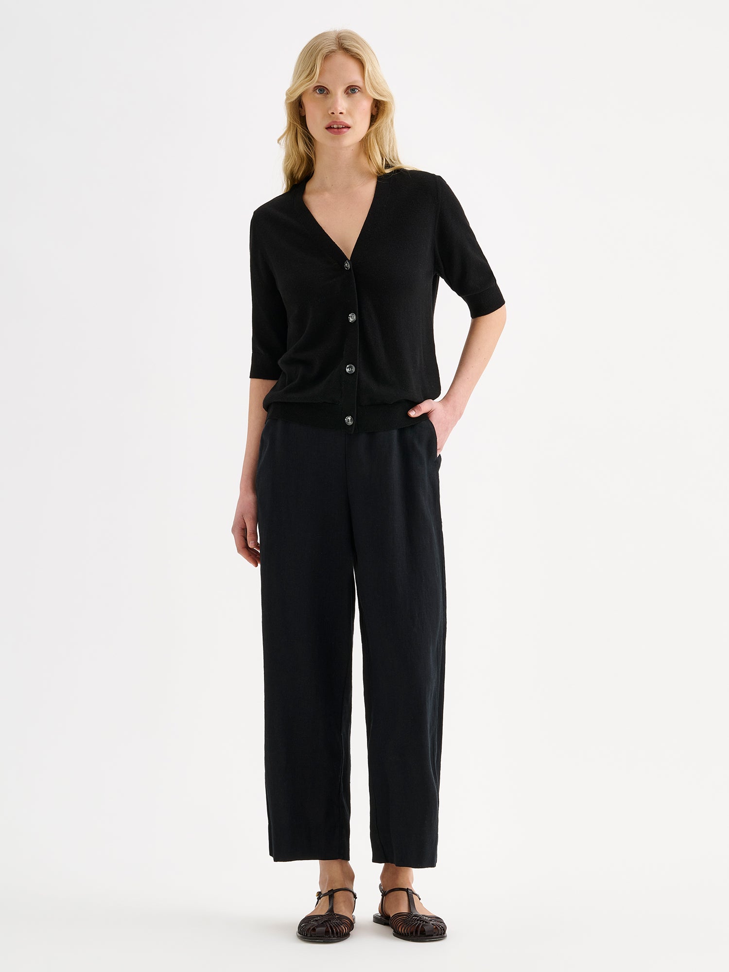 Nanso women's light pink half-sleeve linen blend Karina knit cardigan on a model with black trousers