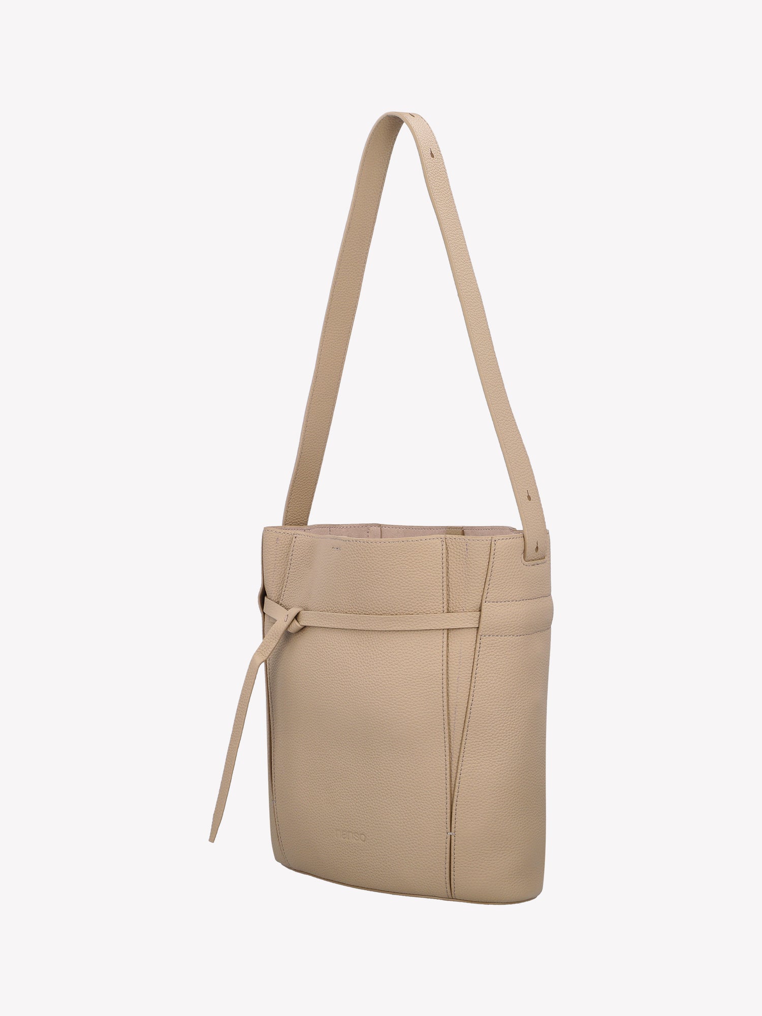 Nanso light beige Naru Bucket leather bag is a timeless accessory. Product picture from the side angle.