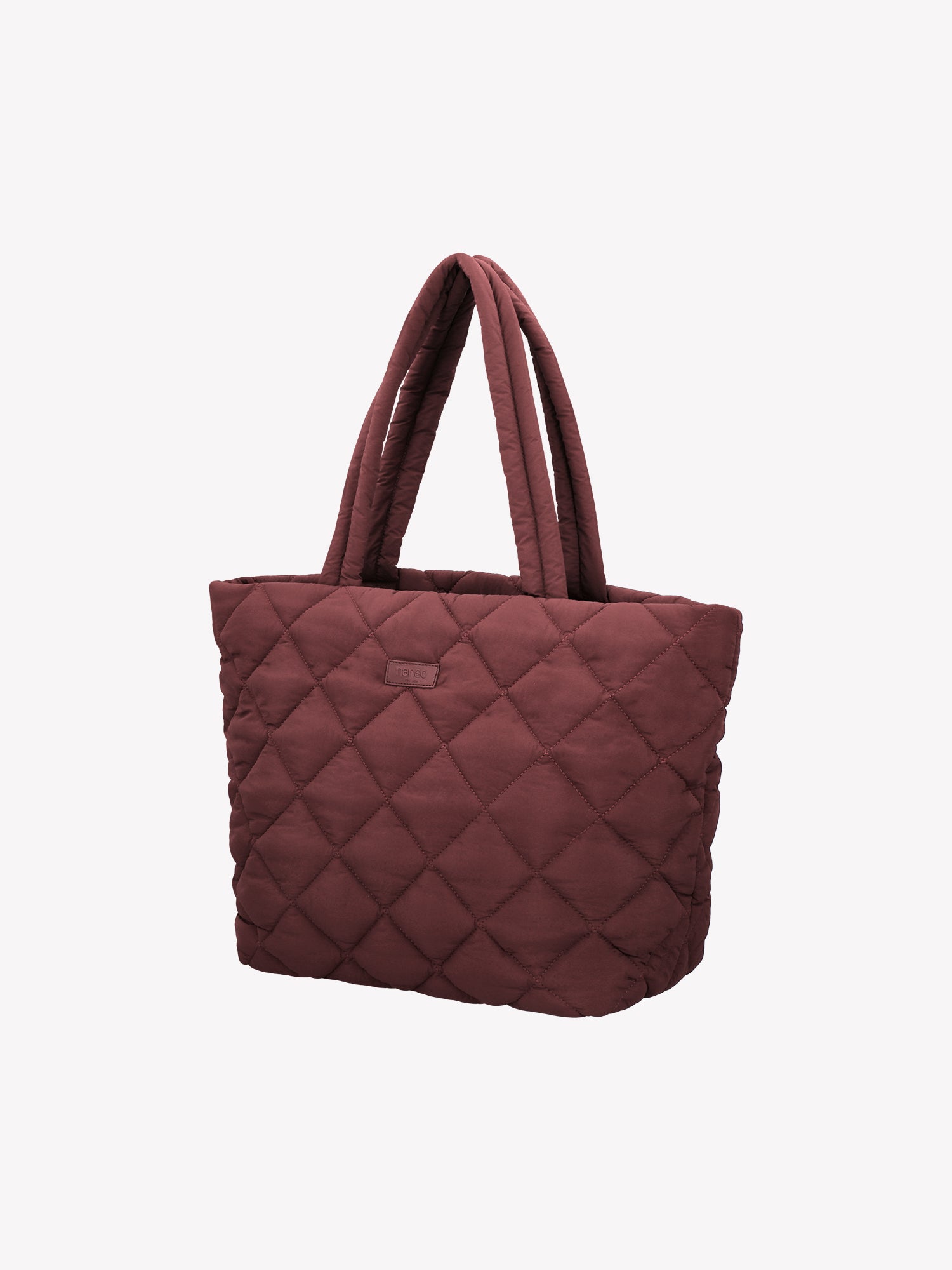 Nanso's trendy winered Maxi Vanu tote bag is crafted from quilted fabric with a thin padding and an elegant stitched pattern on the outer material. It features a zipper closure for secure carrying. Product picture