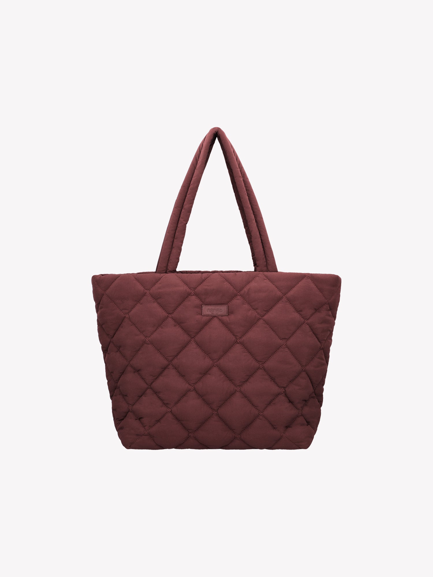 Nanso's trendy winered Maxi Vanu tote bag is crafted from quilted fabric with a thin padding and an elegant stitched pattern on the outer material. It features a zipper closure for secure carrying. Product picture