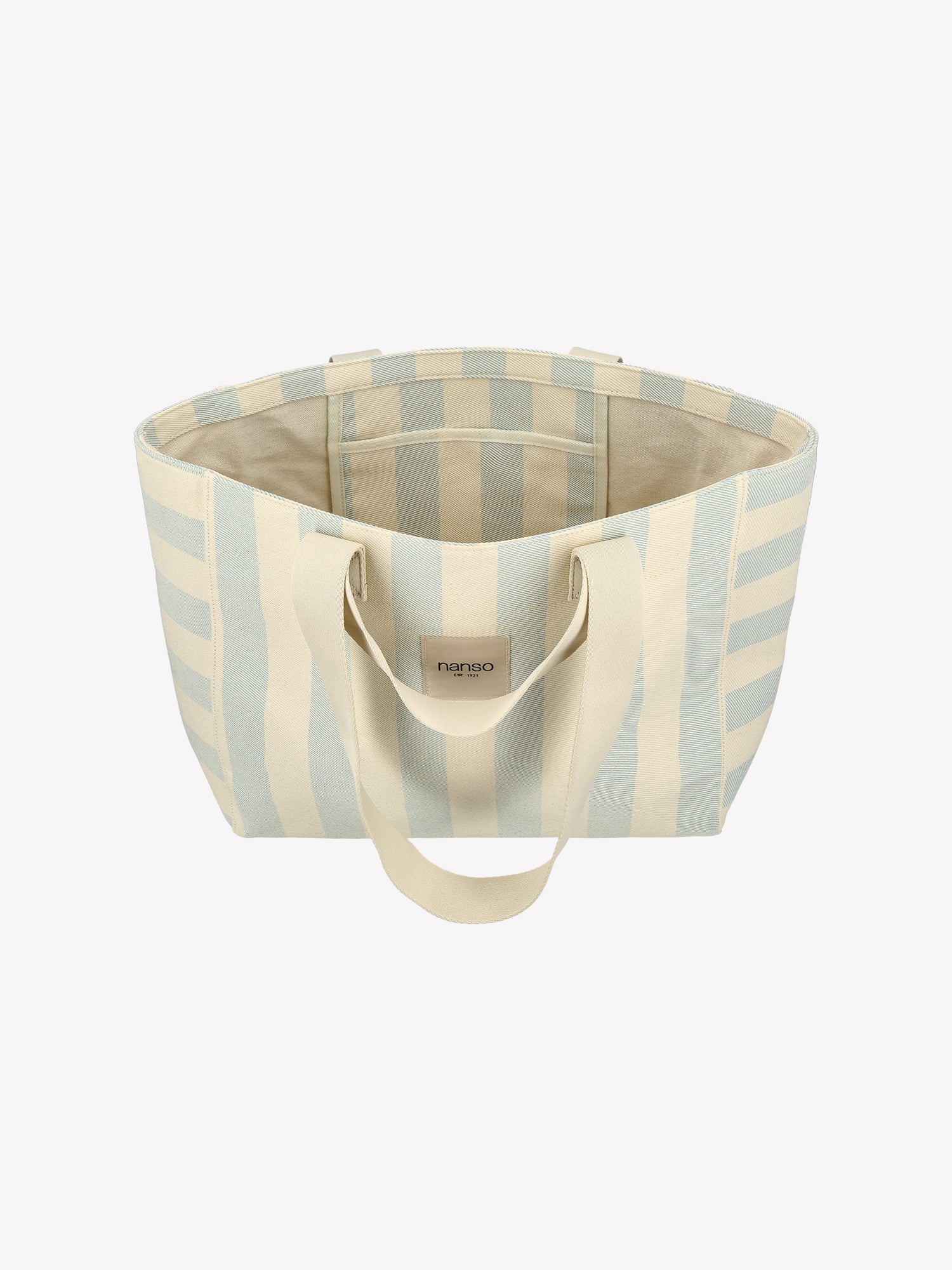 The Amalfi Beach bag brings effortless style to your adventures with its crisp light blue and white striped design. Crafted from durable fabric with dual handles. Product picture from the above.