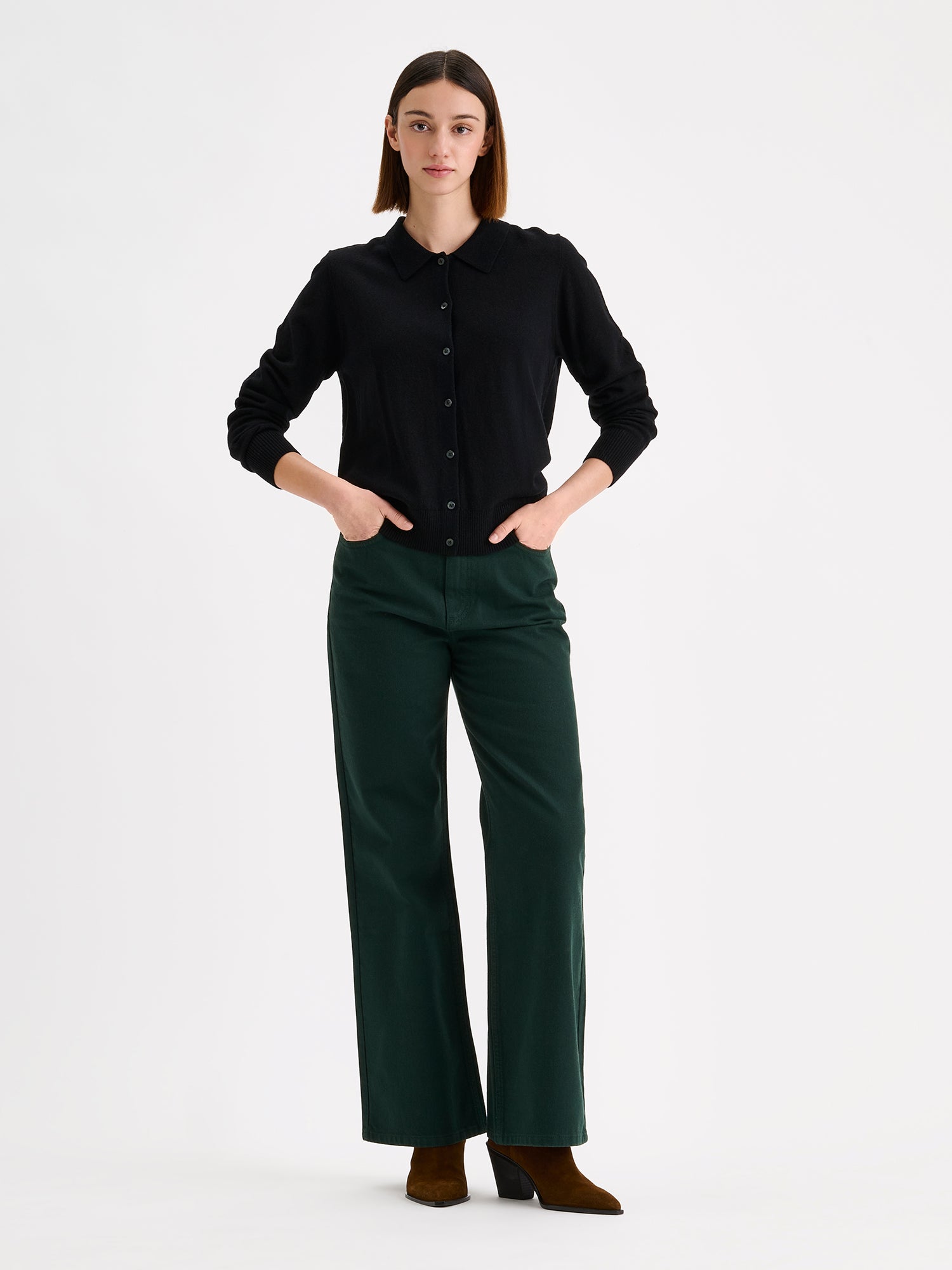 Nanso women's timeless black collared Villis cardigan on a model with dark green jeans